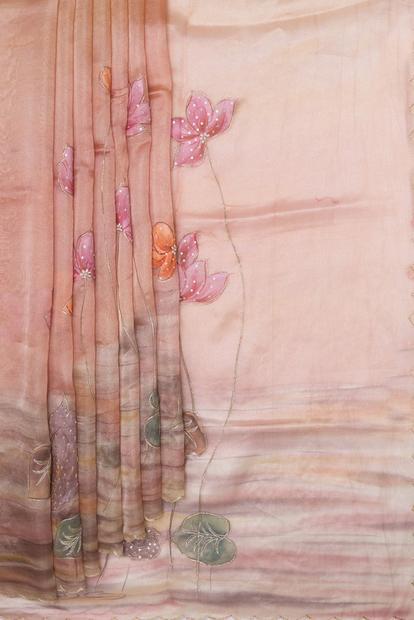 Pleats and pallu of Rose Gold Dual Tone Organza Silk Saree with Embroidery on the body and Embroidery Border. 