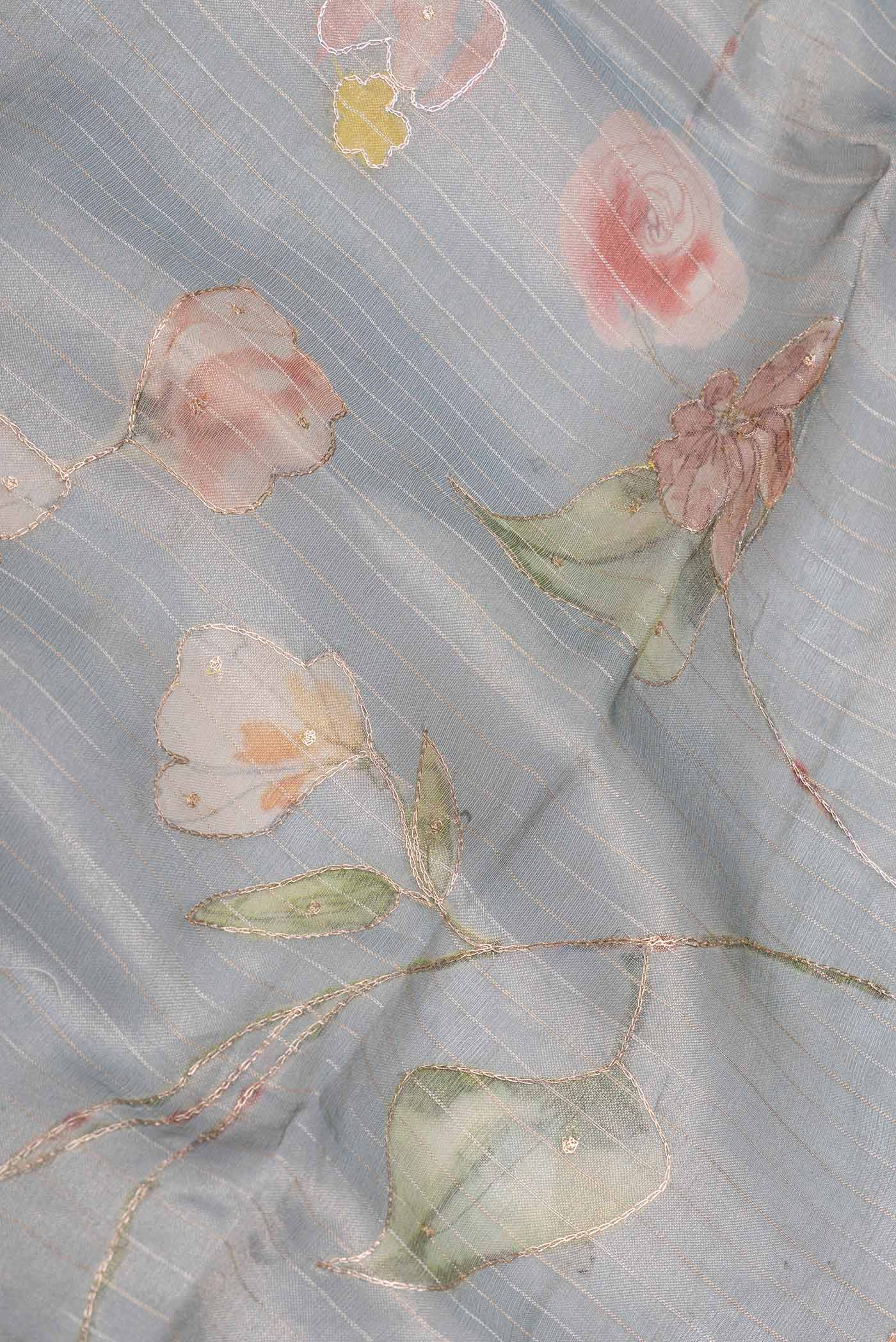 Close up of Blue Grey Organza Silk Saree with Embroidery on the body and Embroidery Border displaying folds
