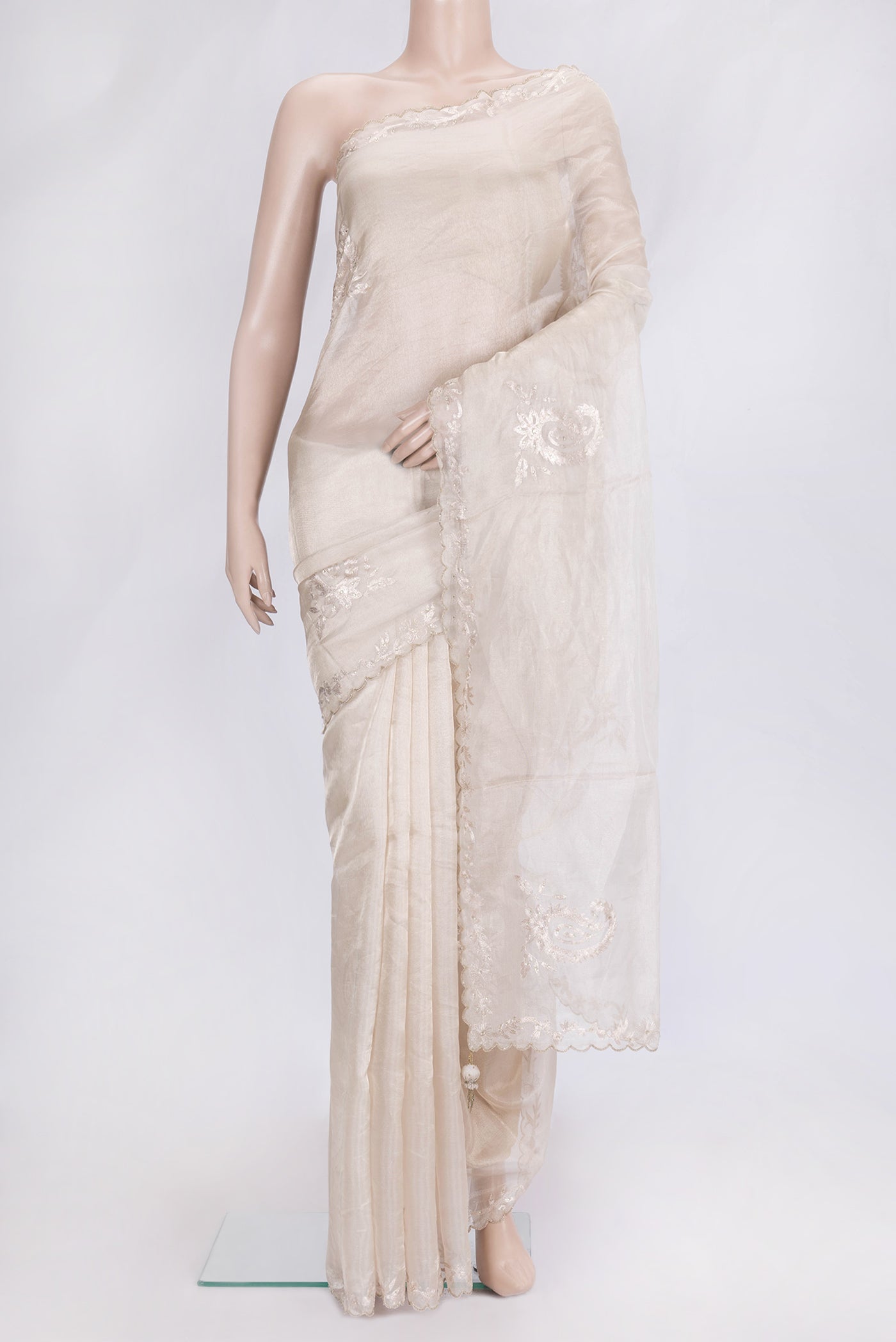 Beige Dual Tone Organza Silk Saree with Embroidery on the body and Embroidery Border.  displayed on a mannequin