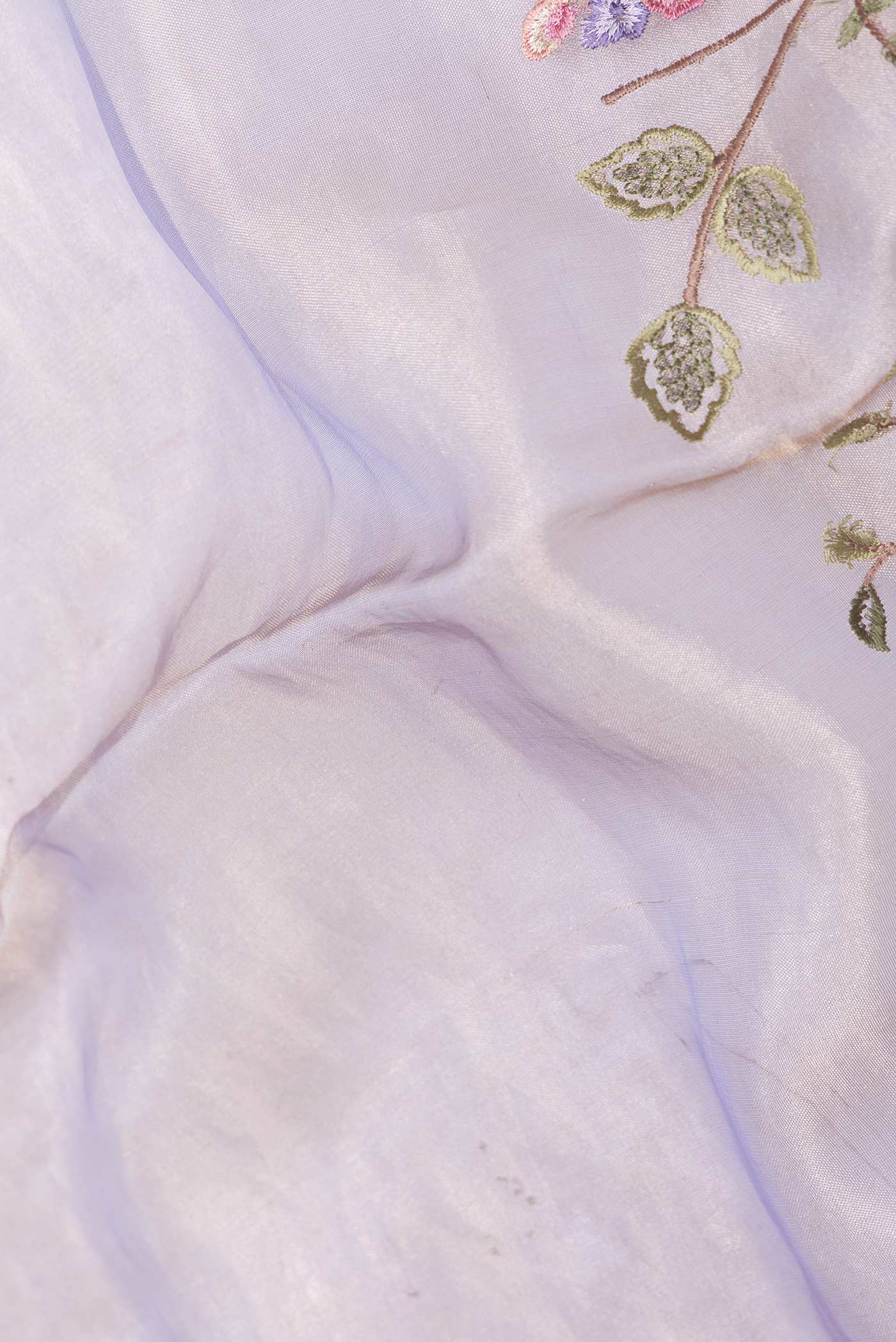 Close up of Lavender Dual Tone Organza Silk Saree with Embroidery on the body and Zari Border displaying folds