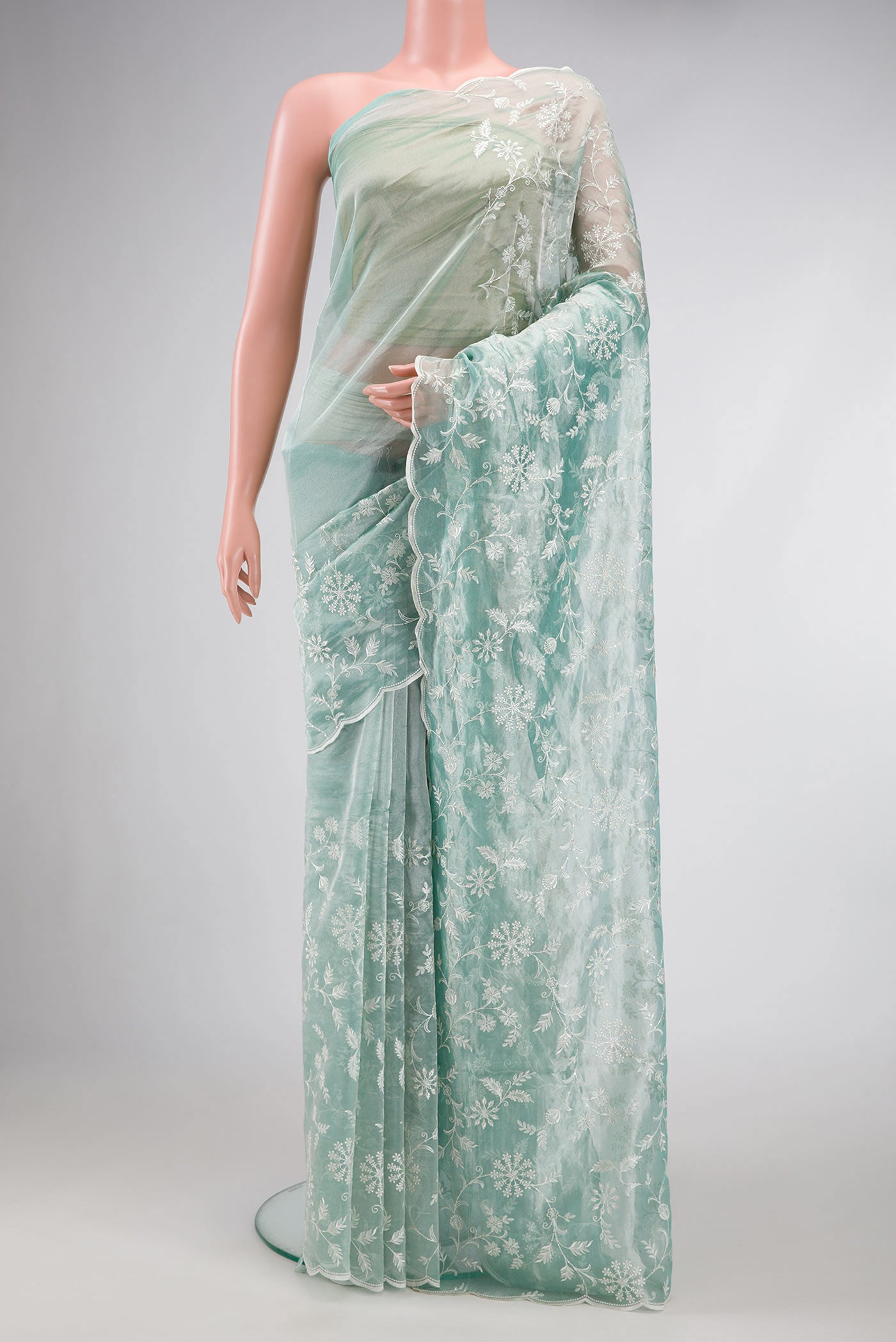 Sea Green Dual Tone Organza Silk Saree with Embroidery on the body and Embroidery Border.  displayed on a mannequin