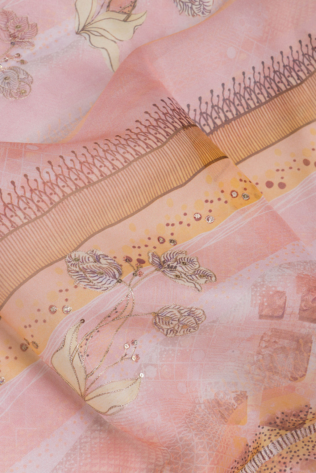Close up of Peach Organza Silk Saree with Embroidery on the body and Embroidery Border.  displaying folds