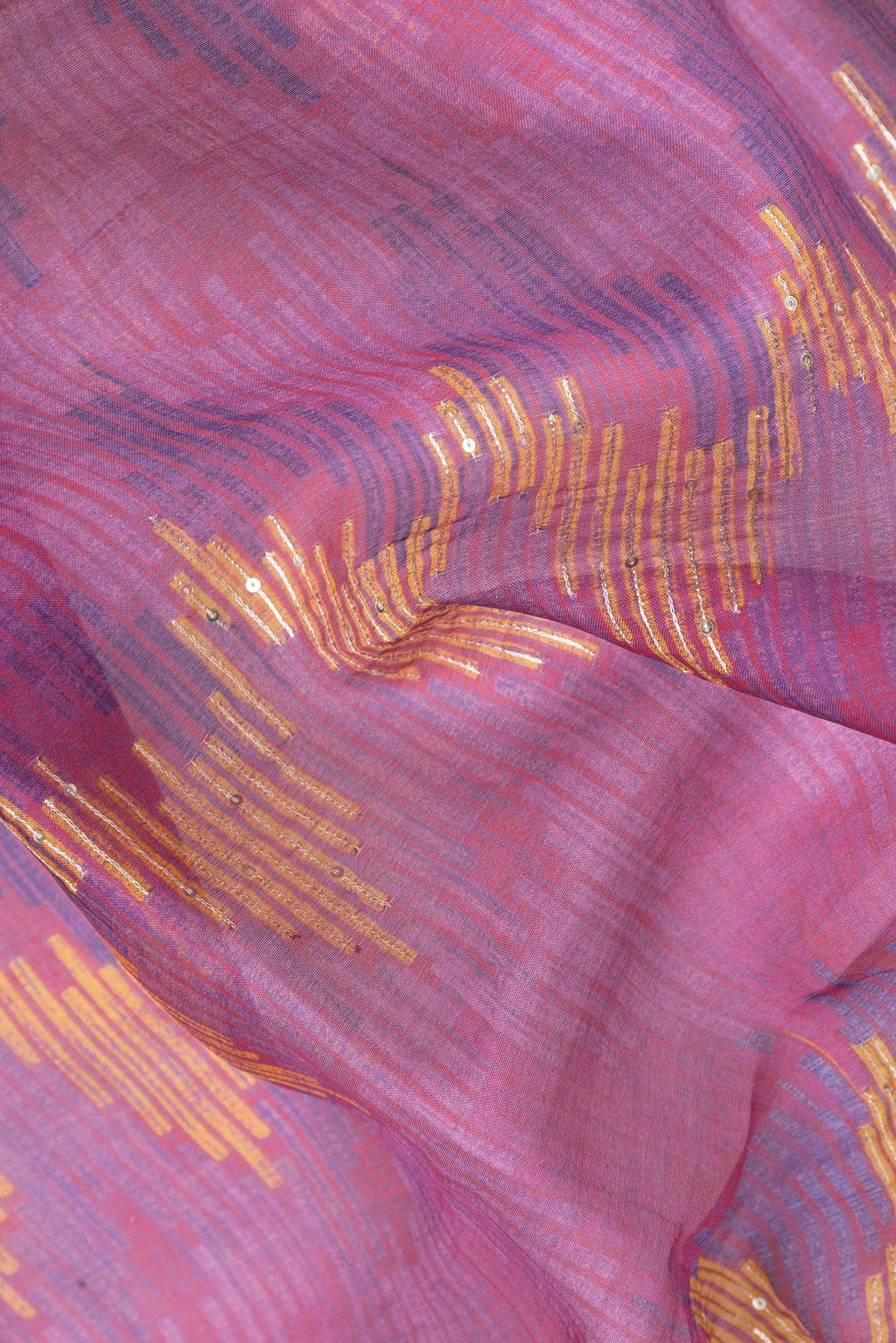 Close up of Magenta Dual Tone Tussar Silk Saree with Embroidery on the body and Embroidery Border.  displaying folds