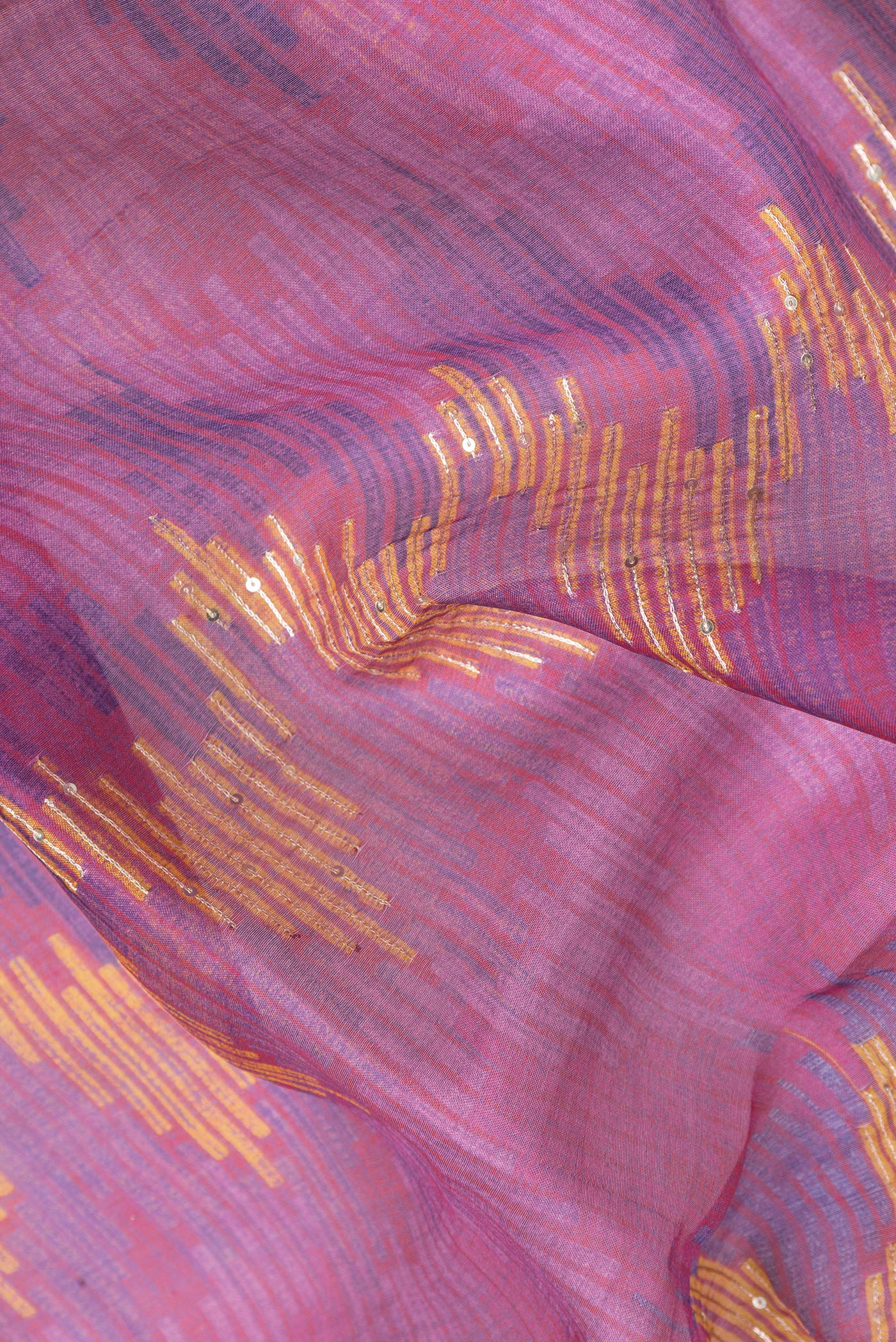 Close up of Magenta Dual Tone Tussar Silk Saree with Embroidery on the body and Embroidery Border.  displaying folds