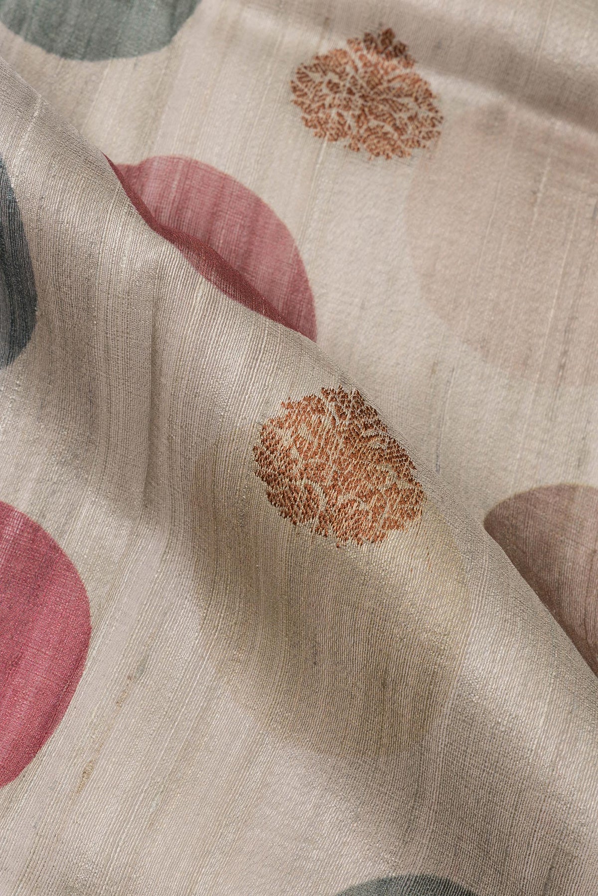 Close up of Pure Silk Dark Beige Tussar Saree with Zari Butta on the body and Zari Border.  displaying folds