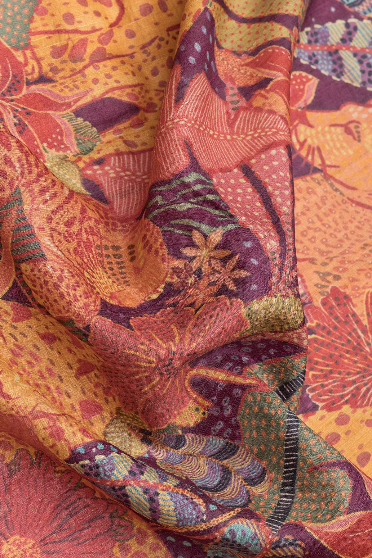 Close up of Purple Dual Tone Tussar Silk Saree with Printed design on the body and Zari Border.  displaying folds