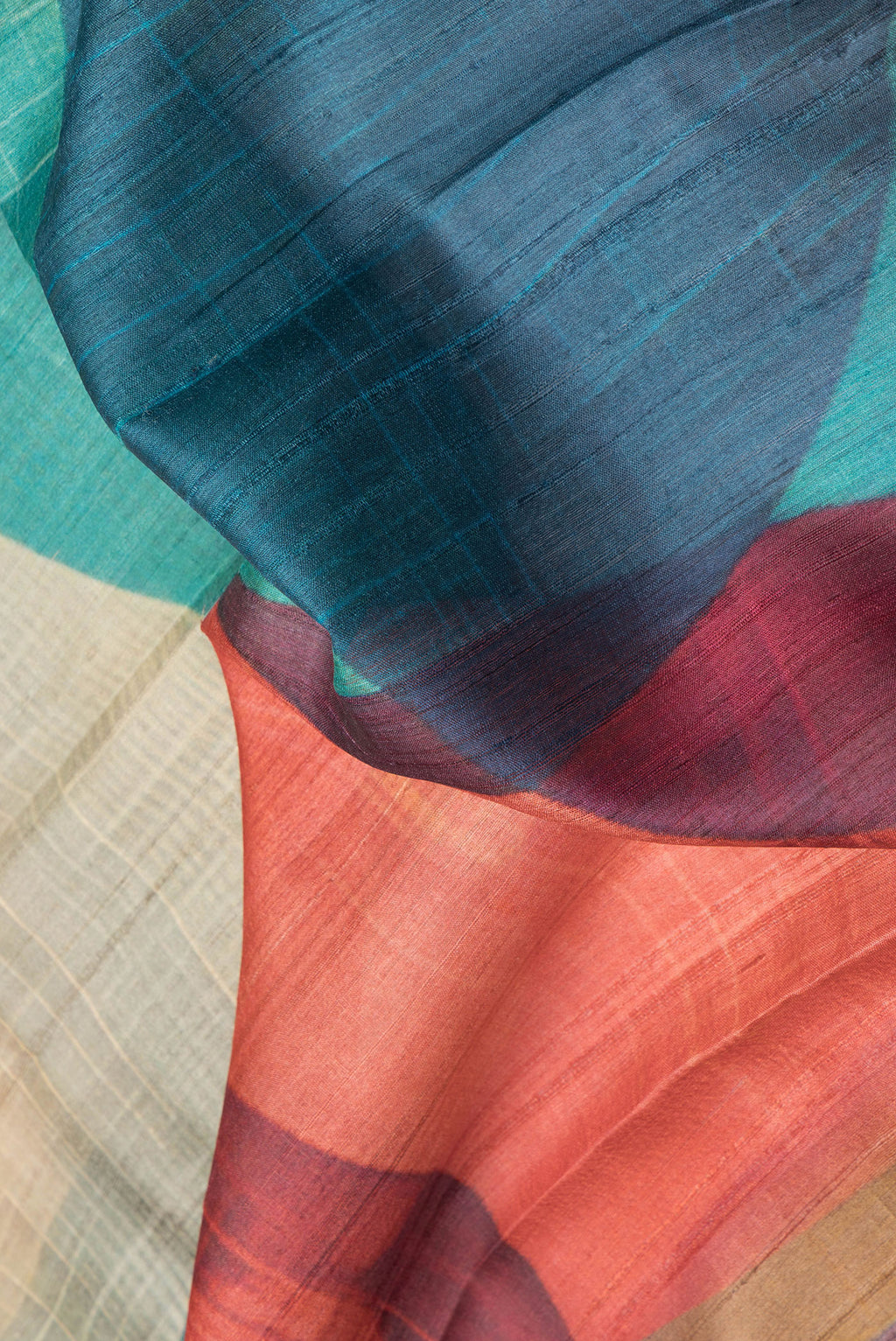 Close up of Maroon Dual Tone Tussar Silk Saree with Printed design on the body and Zari Border.  displaying folds