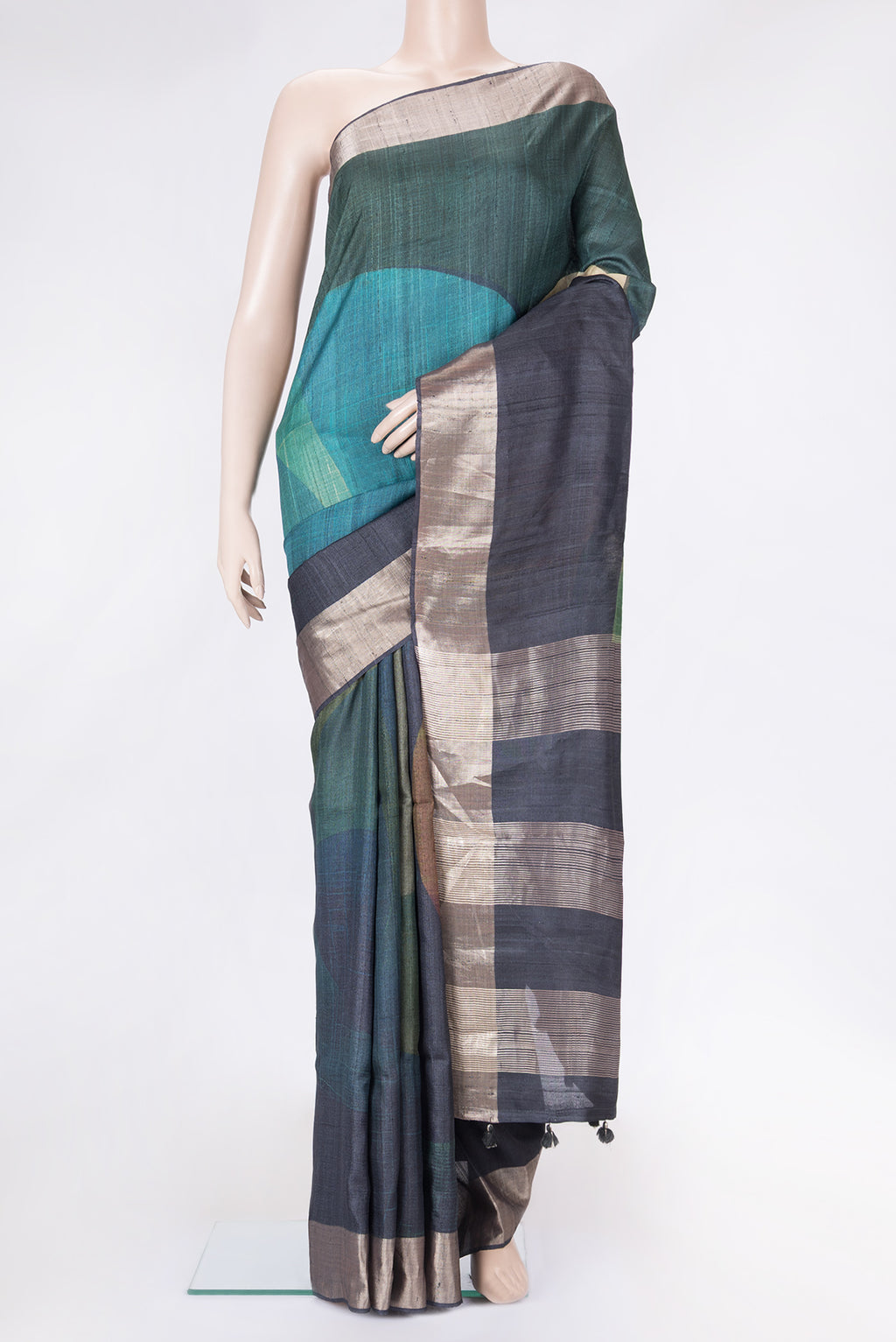 Mustard and Peakcock Blue Color Tussar Silk Saree with Printed design on the body and Zari Border.  displayed on a mannequin