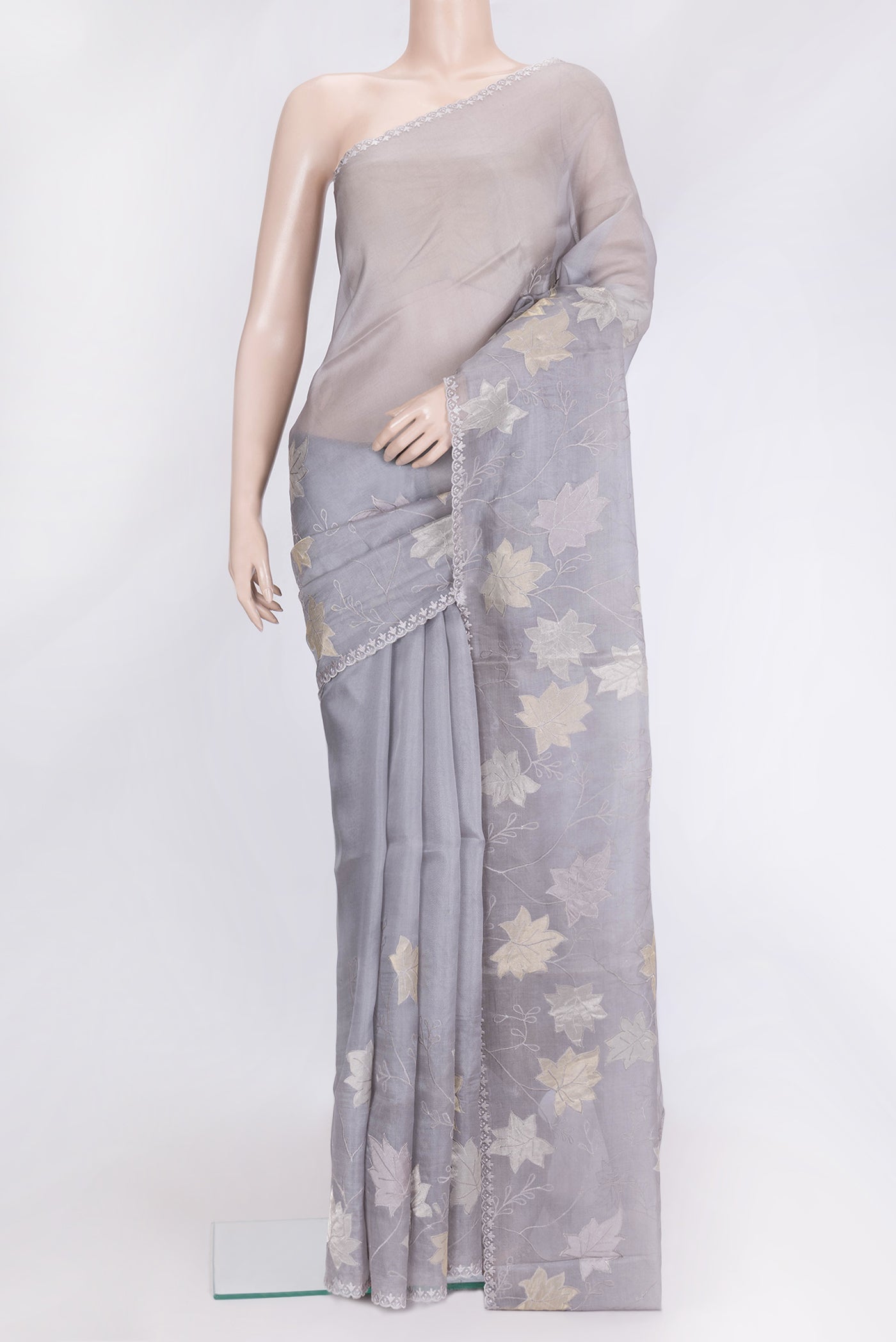 Grey Dual Tone Organza Silk Saree with Embroidery on the body and Embroidery Border.  displayed on a mannequin