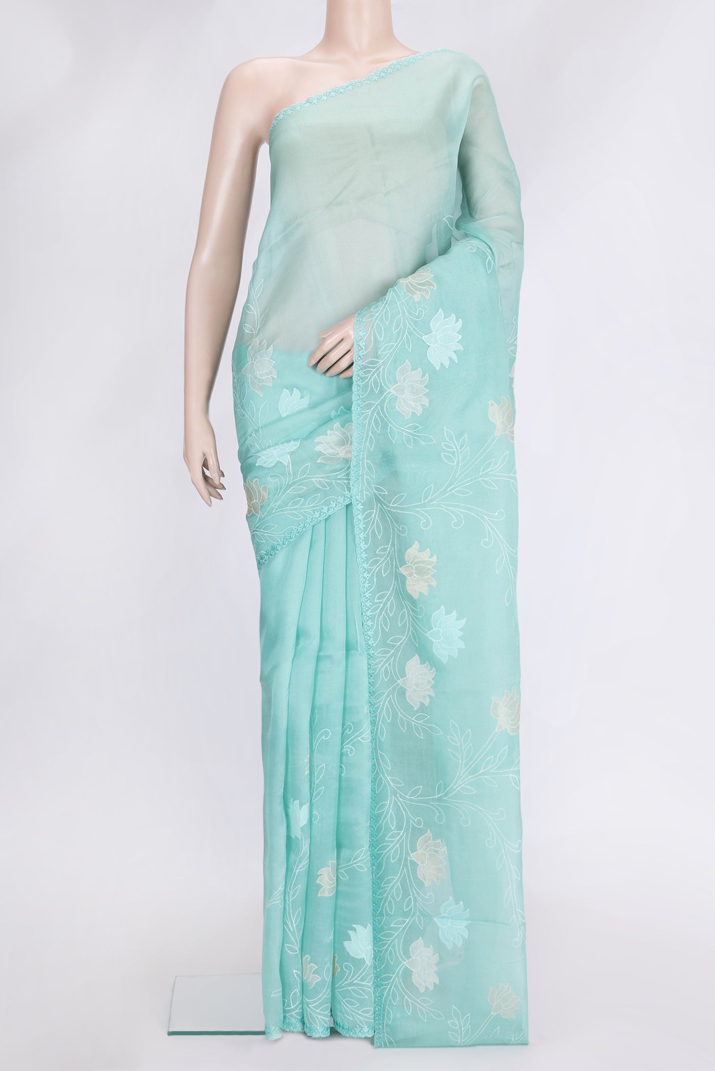Sea Green Dual Tone Organza Silk Saree with Embroidery on the body and Embroidery Border.  displayed on a mannequin