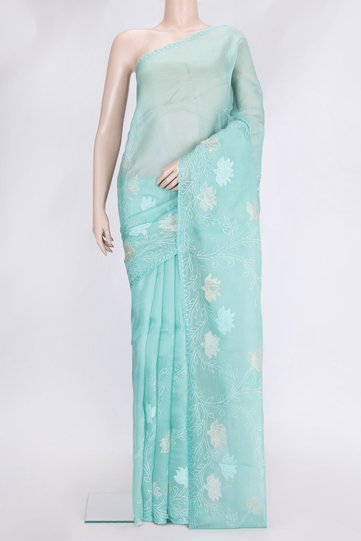 Sea Green Dual Tone Organza Silk Saree with Embroidery on the body and Embroidery Border.  displayed on a mannequin