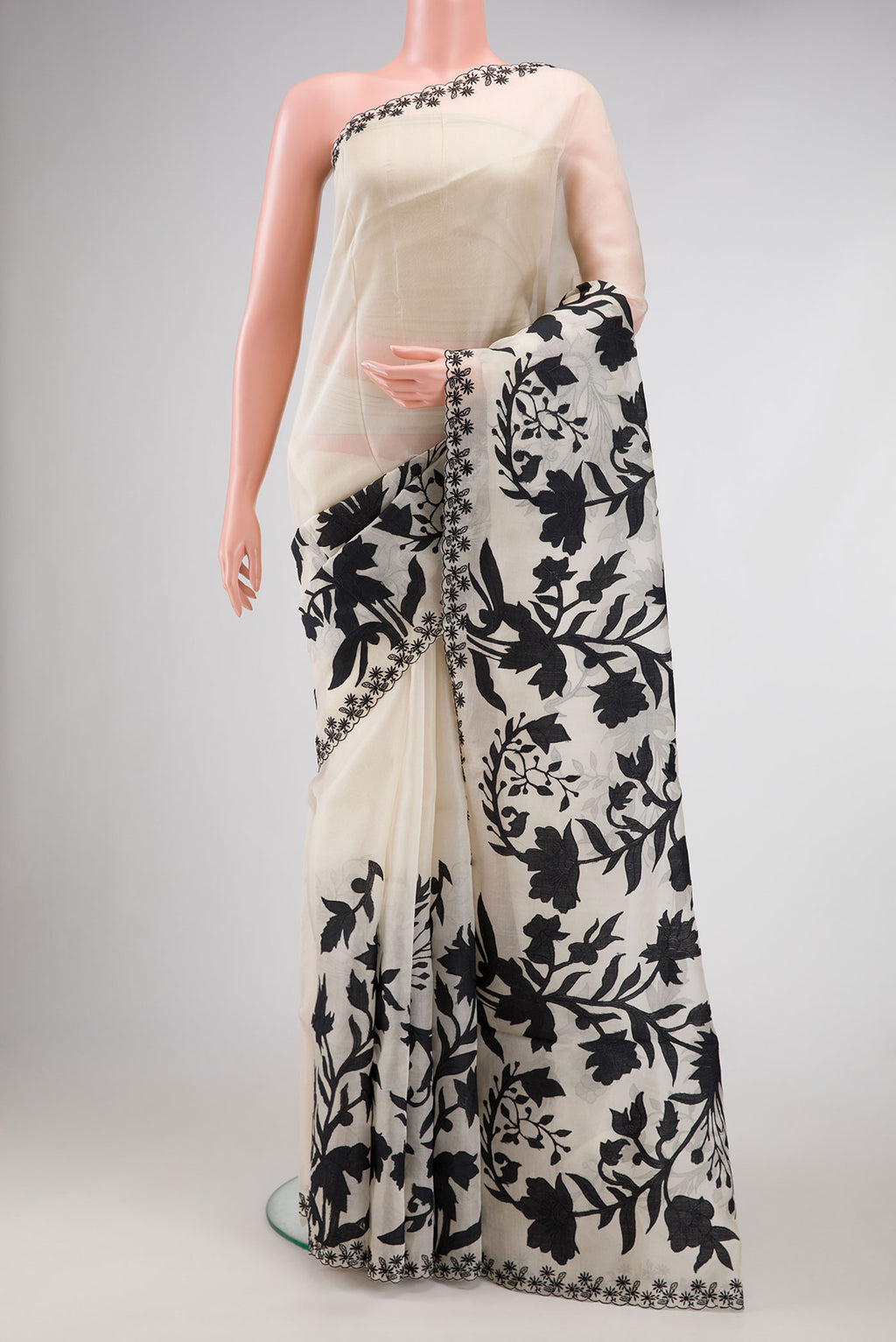 Beige Dual Tone Organza Silk Saree with Embroidery on the body and Embroidery Border.  displayed on a mannequin