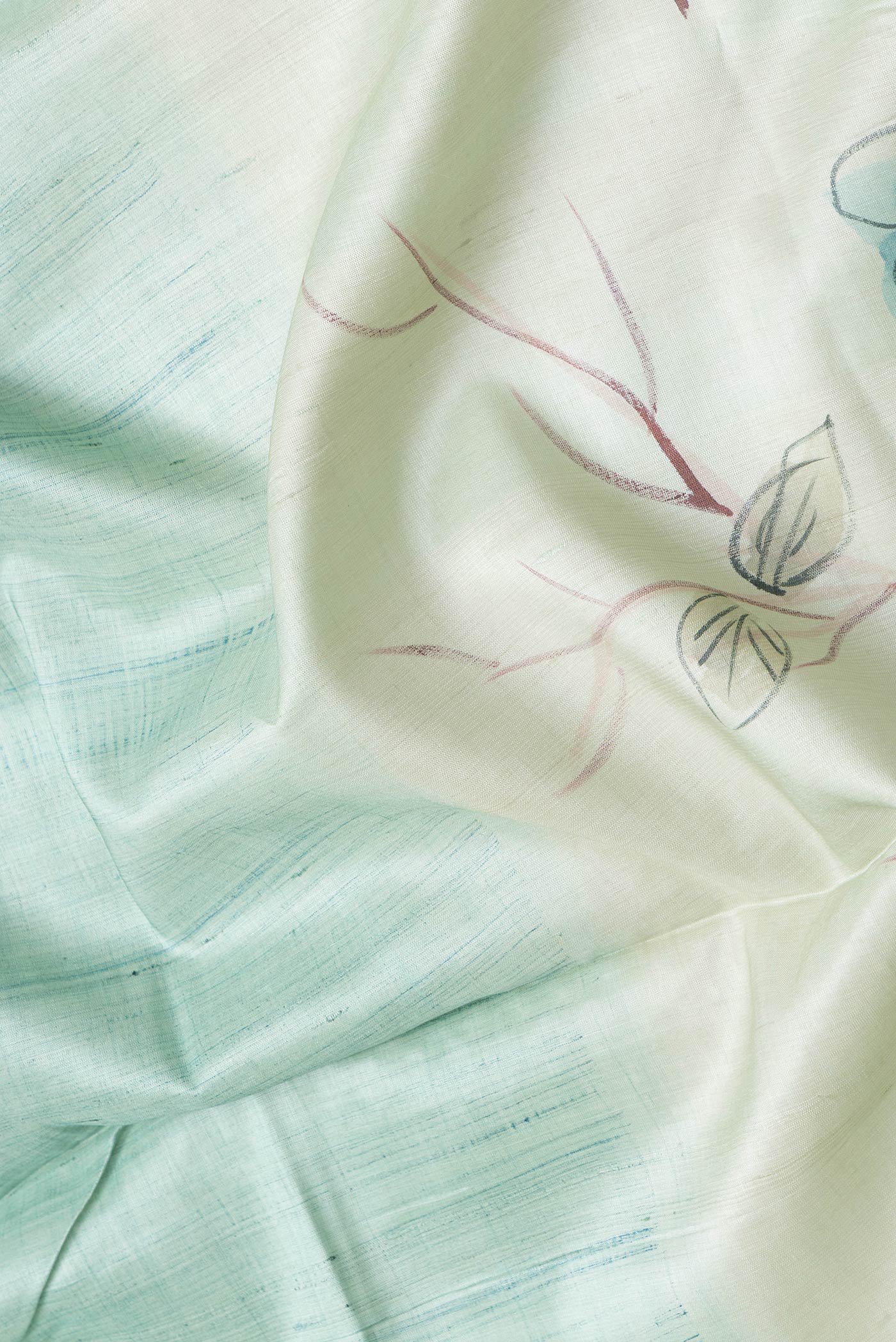 Close up of Pista Green Dual Tone Tussar Silk Saree with Printed design on the body and Without Border.  displaying folds