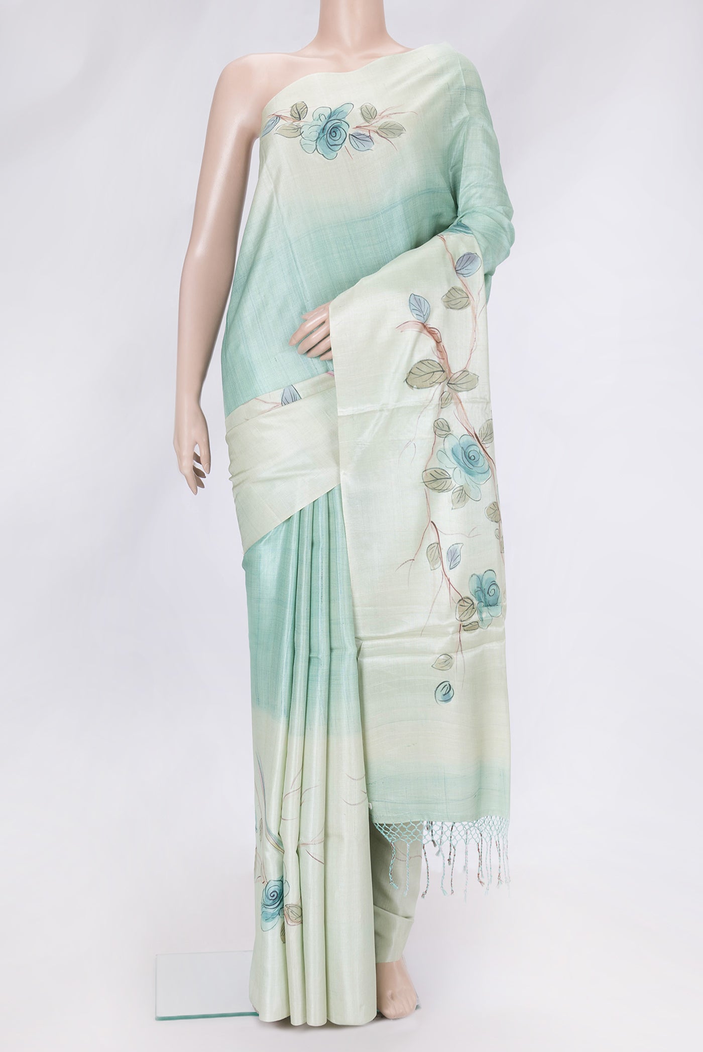 Pista Green Dual Tone Tussar Silk Saree with Printed design on the body and Without Border.  displayed on a mannequin
