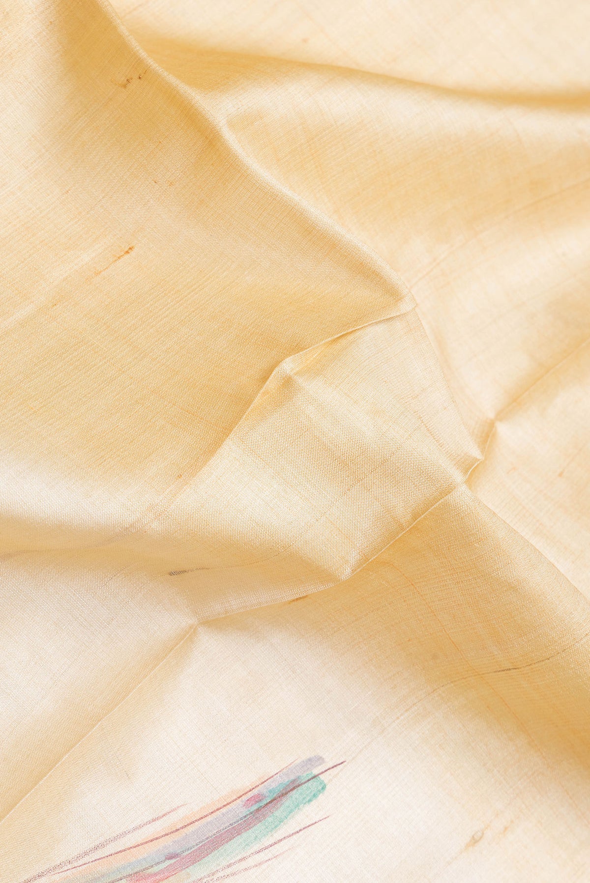 Close up of Beige Dual Tone Tussar Silk Saree with Plain Body and Printed Border.  displaying folds