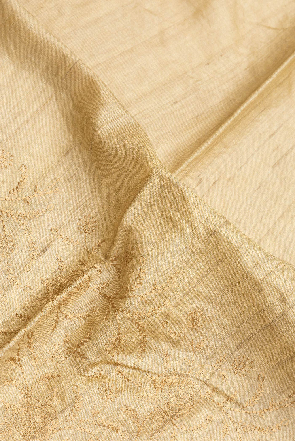 Close up of Sandal Dual Tone Tussar Silk Saree with Embroidery on the body and Printed Border.  displaying folds