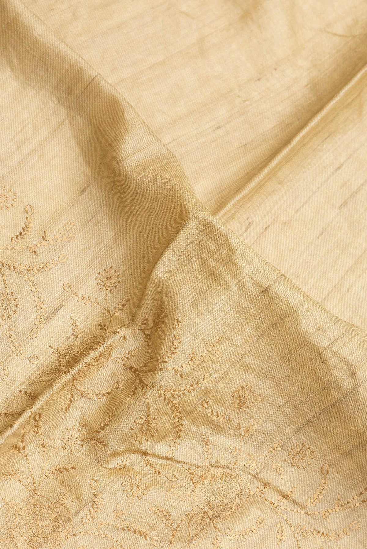 Close up of Sandal Dual Tone Tussar Silk Saree with Embroidery on the body and Printed Border.  displaying folds