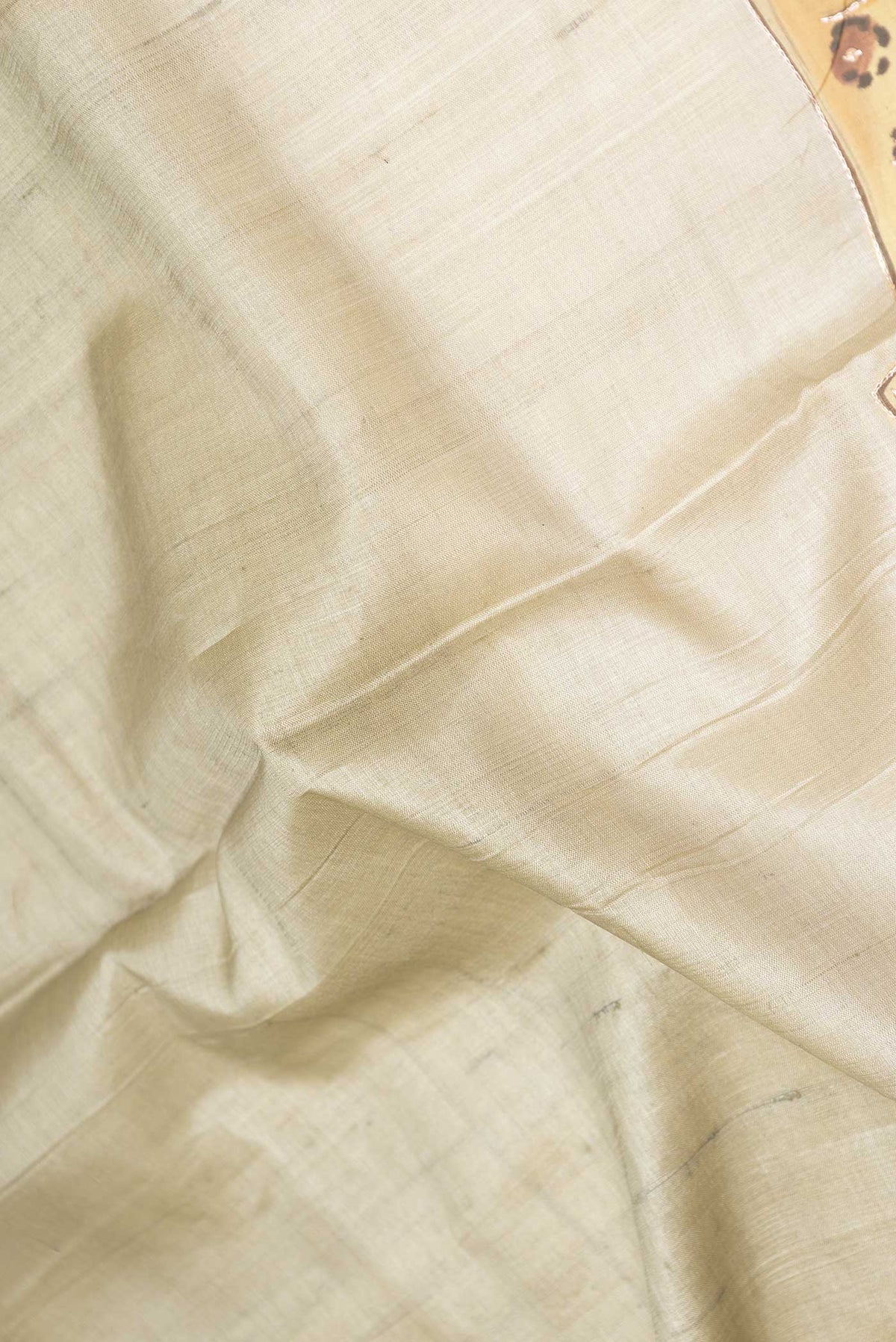 Close up of Green Dual Tone Tussar Saree with Zari And Thread Butta on the body and Without Border displaying folds