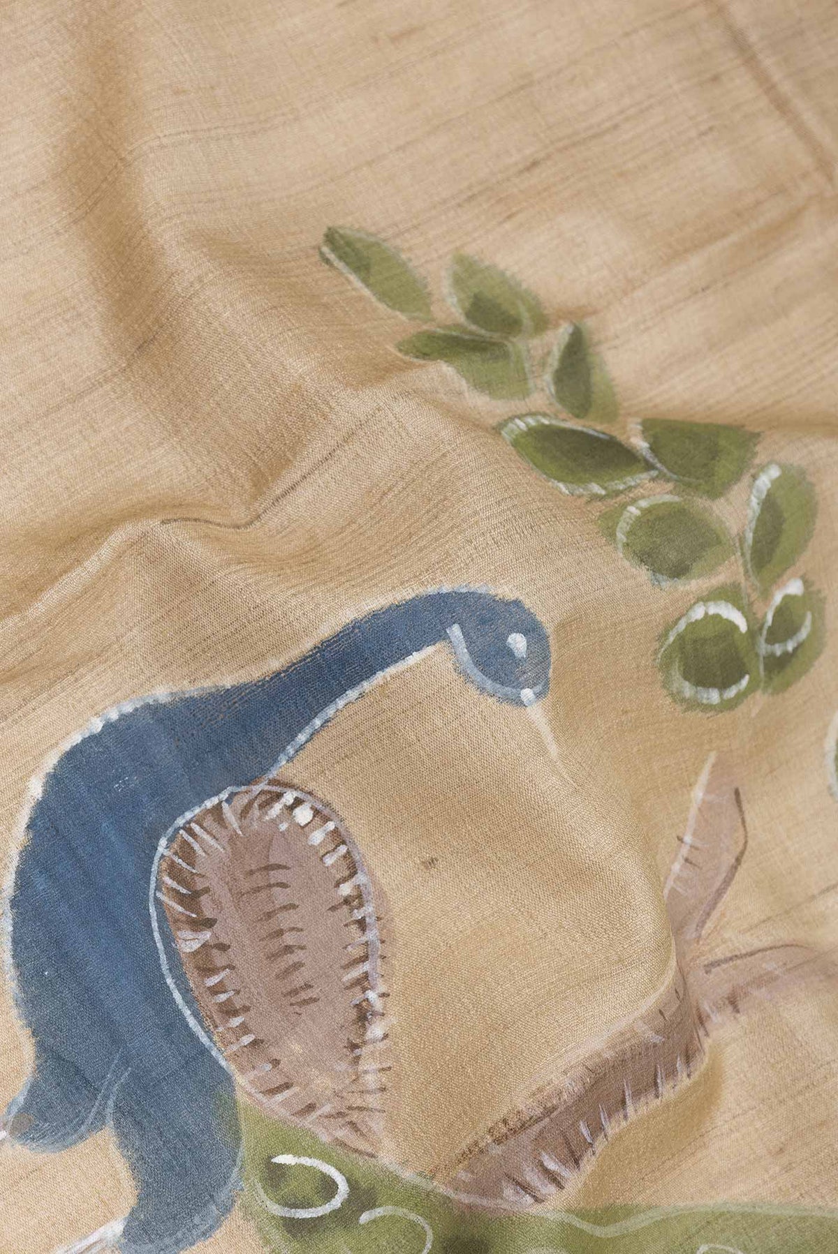 Close up of Beige Dual Tone Tussar SareePrinted design on the body and Embroidery Border displaying folds