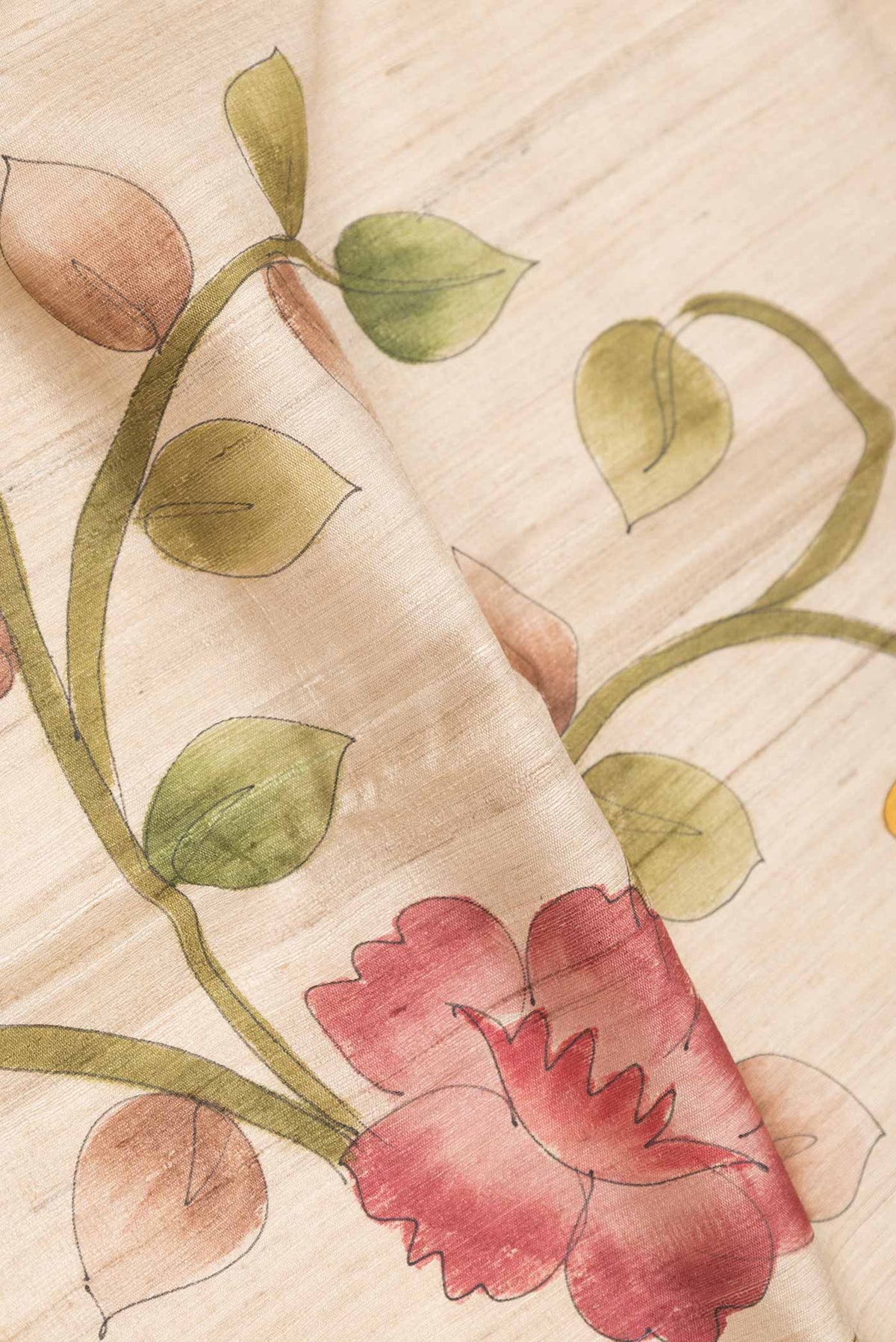 Close up of Beige Dual Tone Tussar Saree with Printed design on the body and Zari Border displaying folds