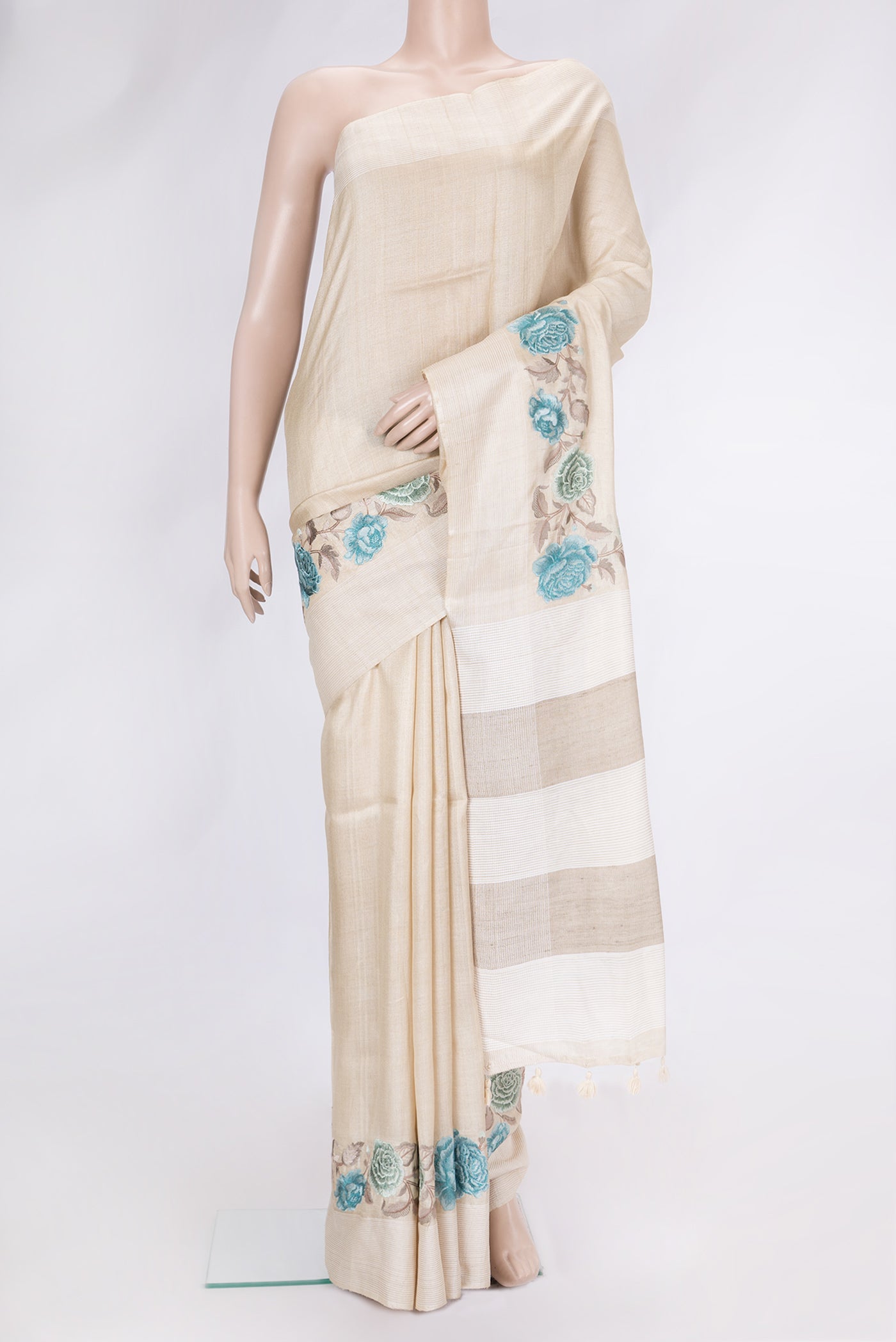 Beige Dual Tone Tussar Silk Saree with Plain Body and Thread Border.  displayed on a mannequin
