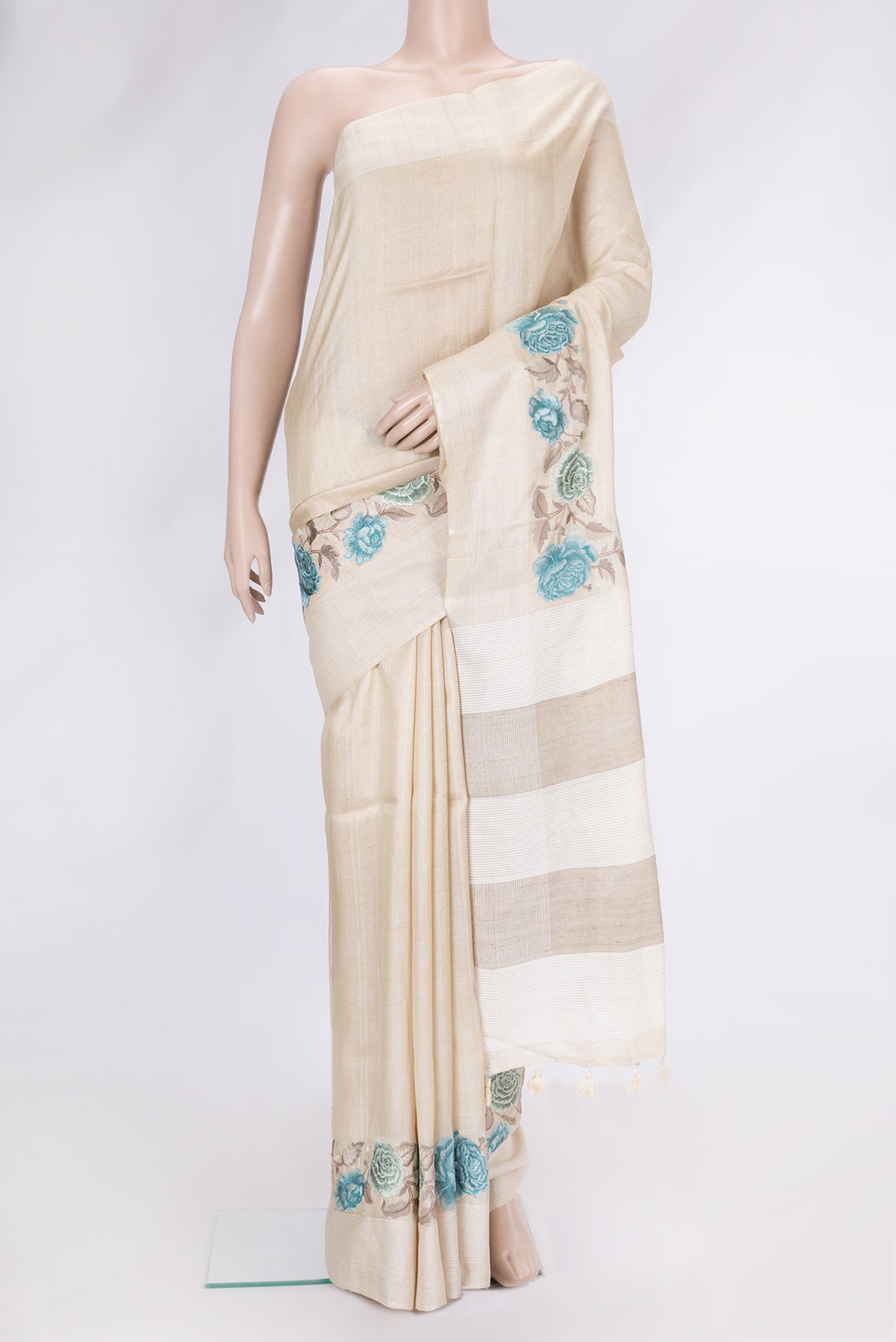 Beige Dual Tone Tussar Silk Saree with Plain Body and Thread Border.  displayed on a mannequin