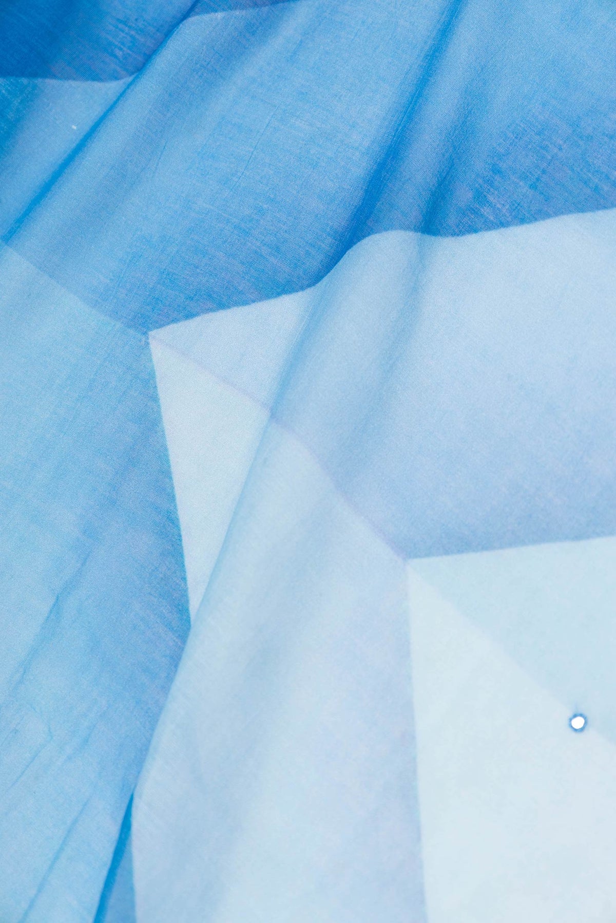 Close up of Blue Dual Tone Tussar Saree with Embroidery on the body and Embroidery Border displaying folds