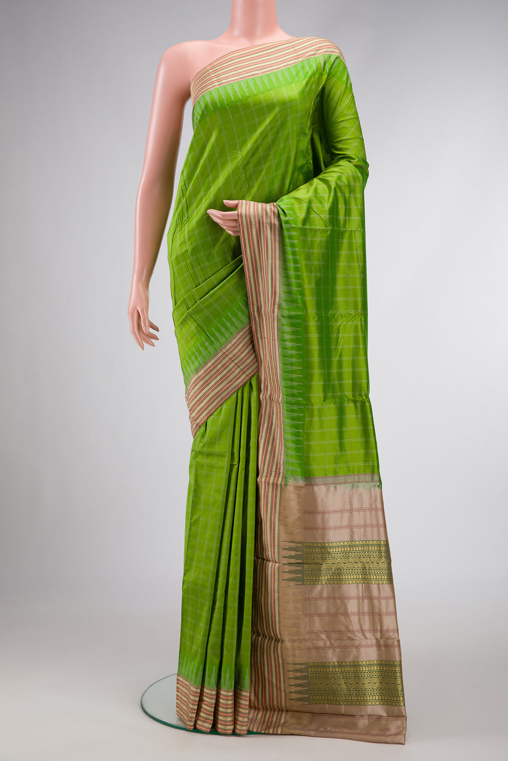 Parrot Green Dual Tone Kanjivaram Silk Saree with Checked design on the body and Zari Border.  displayed on a mannequin