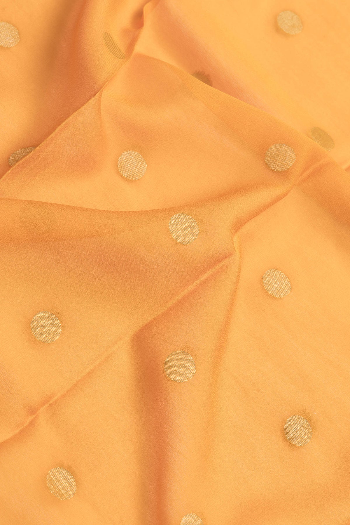 Close up of Mustard Dual Tone Georgette Saree with Zari Butta on the body and Zari Border.  displaying folds
