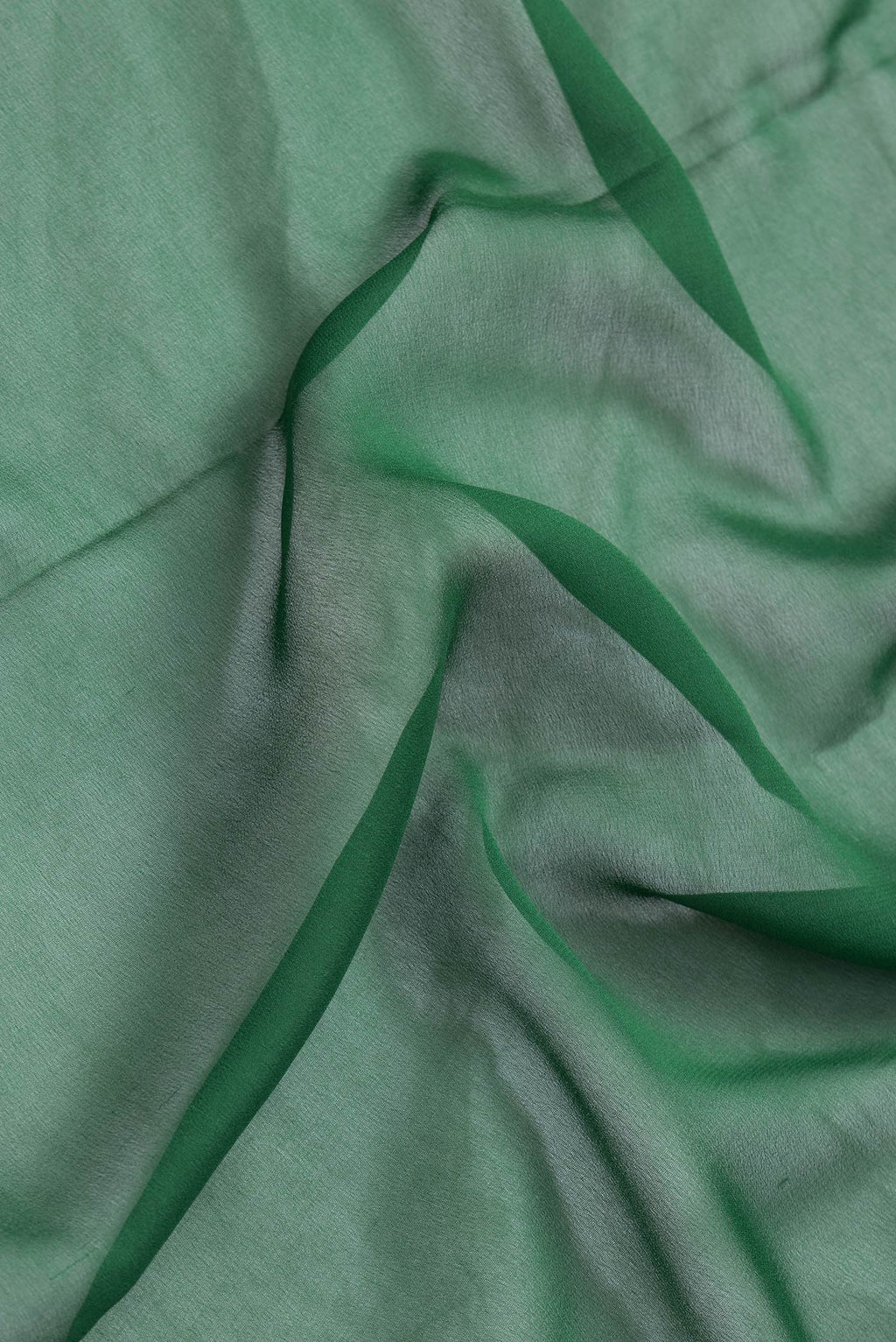 Close up of Bottle Green Dual Tone Mysore Georgette Saree with Plain Body and Zari Border.  displaying folds