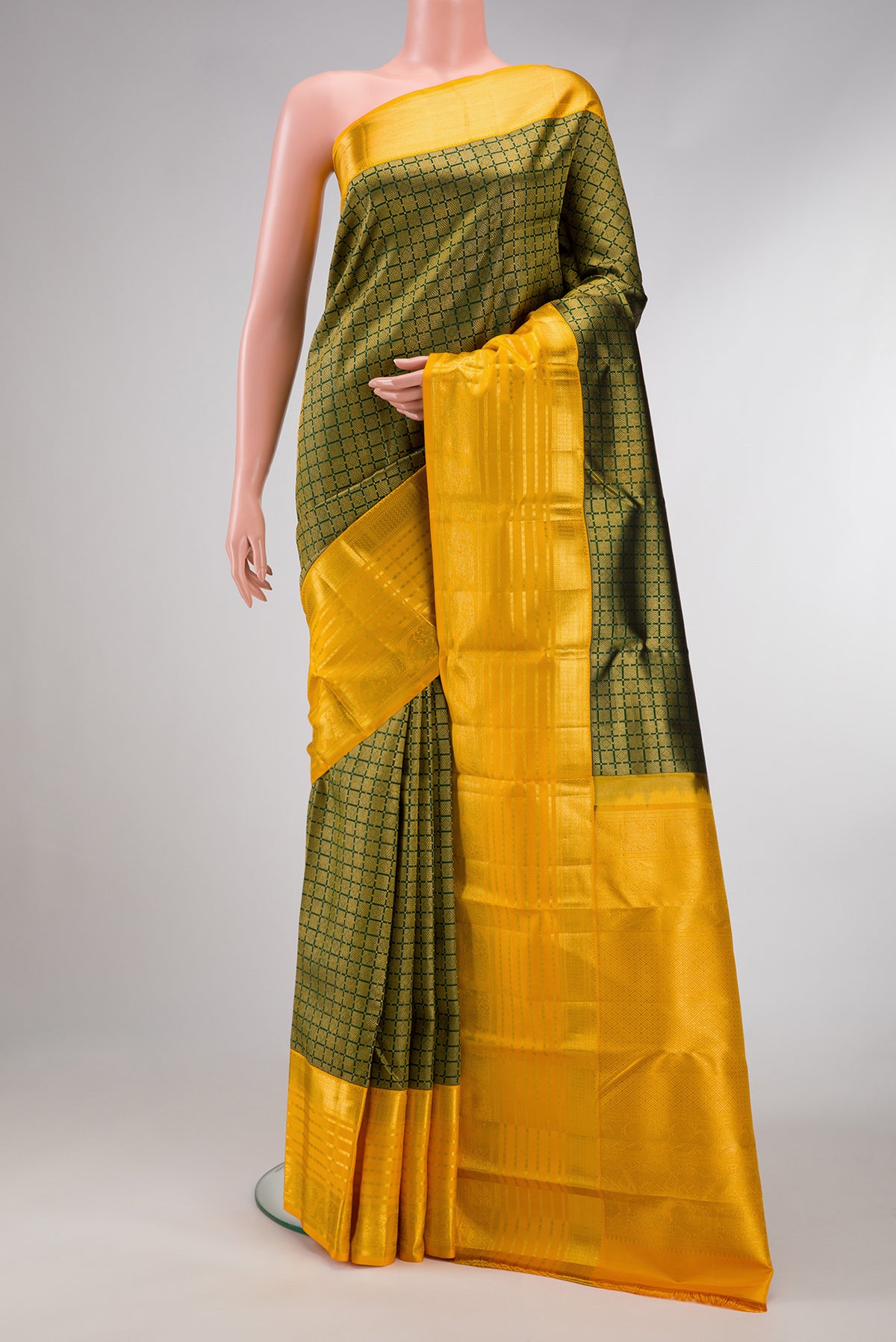 Bottle Green Dual Tone Kanjivaram Silk Saree with Zari Brocade on the body and Zari Border.  displayed on a mannequin