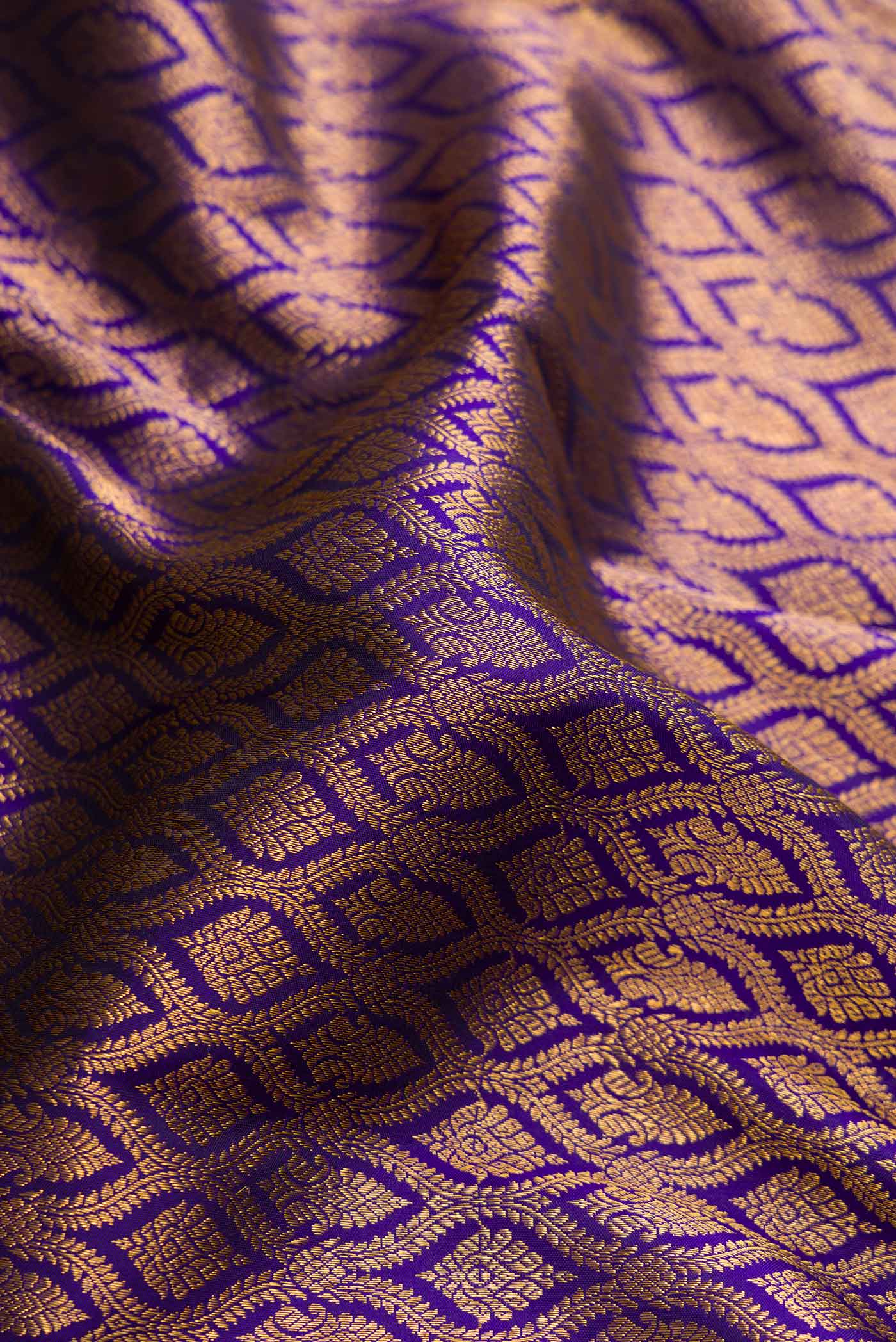 Close up of Navy Blue Dual Tone Kanjivaram Silk Saree with Zari Brocade on the body and Zari Border.  displaying folds