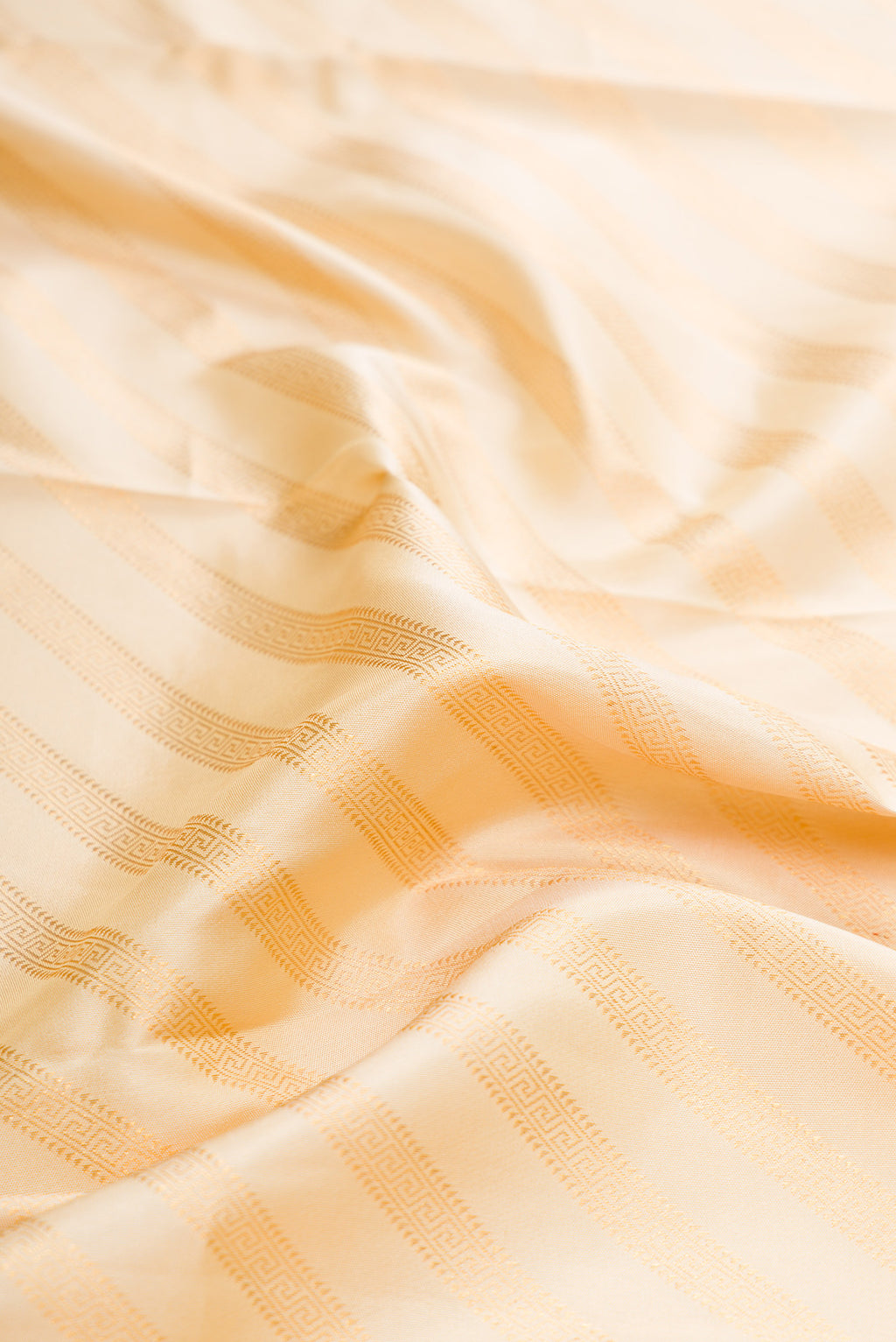 Close up of Sandal Dual Tone Kanjivaram Silk Saree with Zari Brocade on the body and Zari Border.  displaying folds