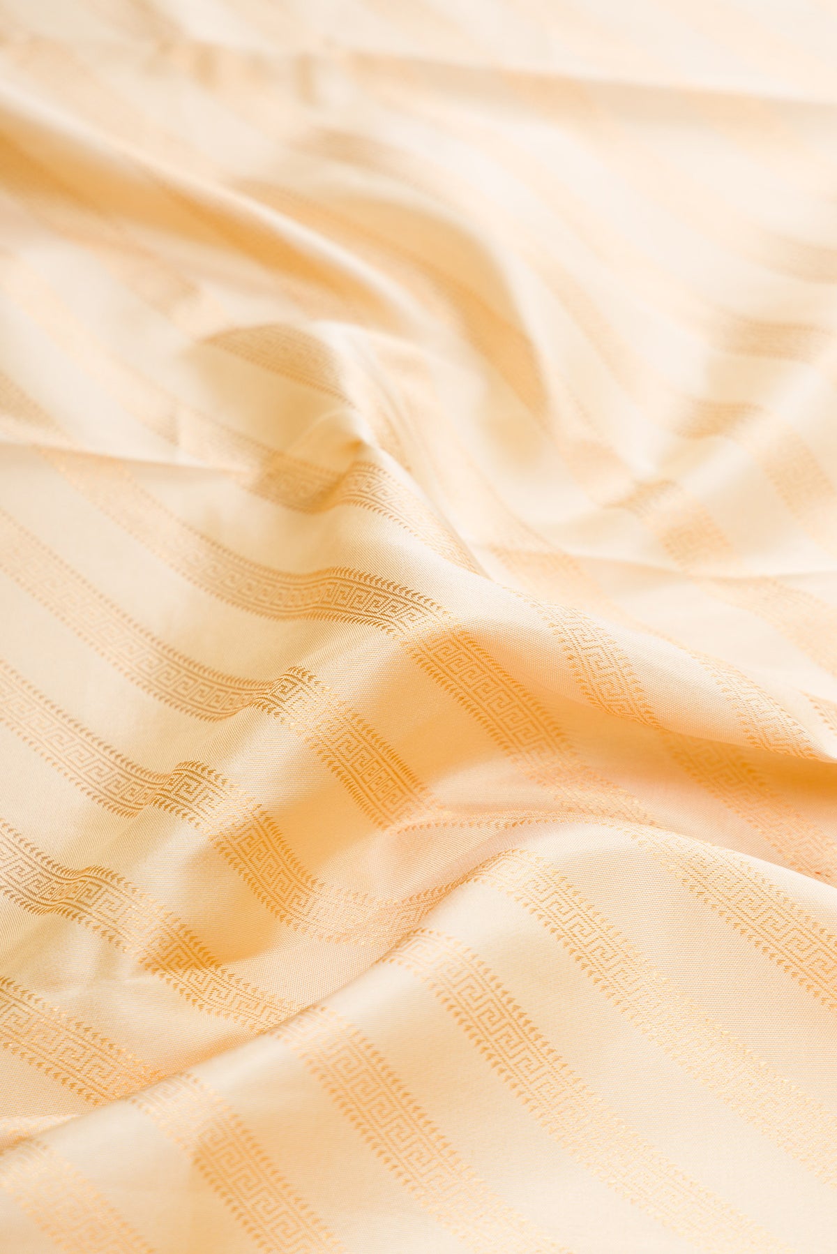 Close up of Sandal Dual Tone Kanjivaram Silk Saree with Zari Brocade on the body and Zari Border.  displaying folds