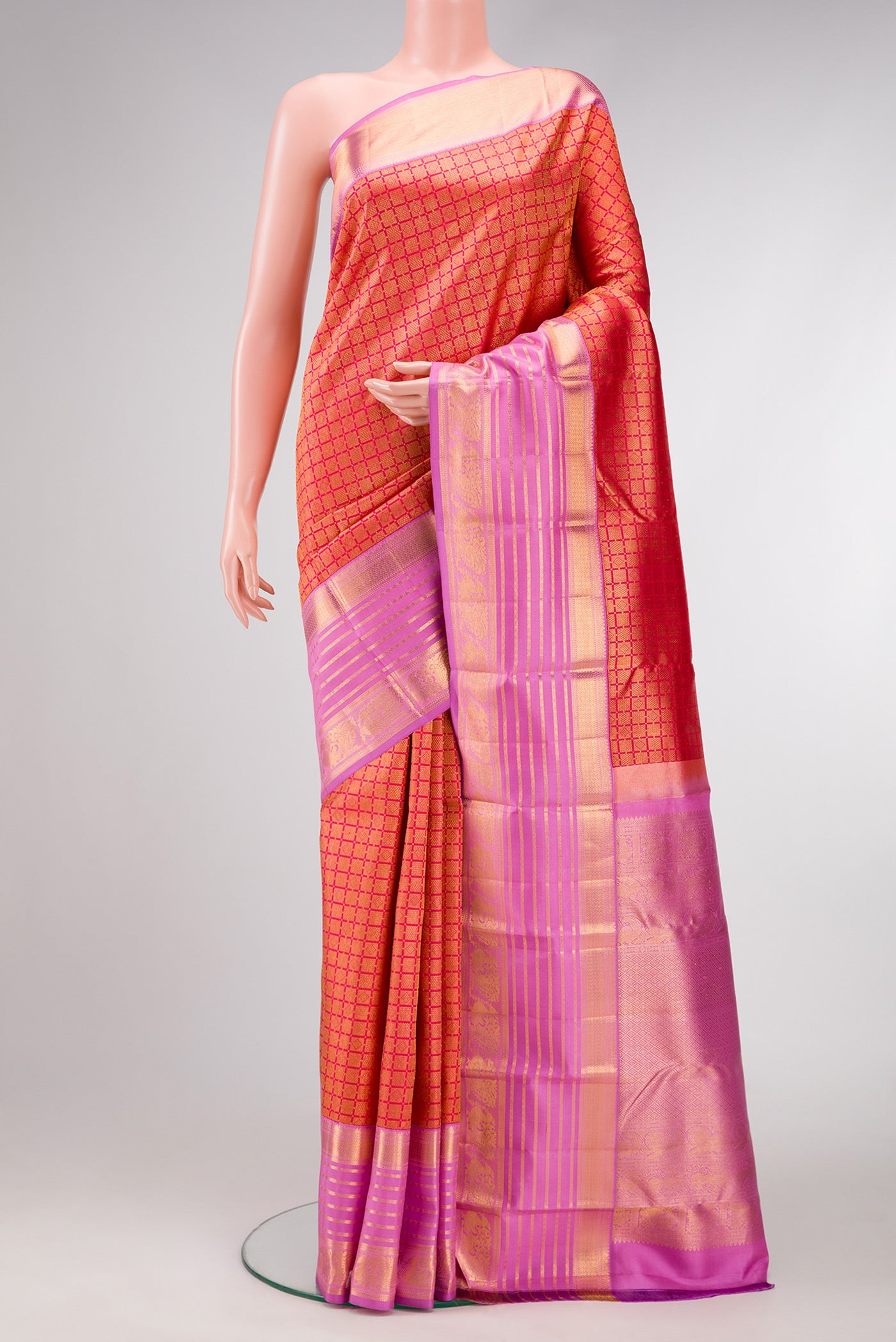 Brick Orange Dual Tone Kanjivaram Silk Saree with Zari Brocade on the body and Zari Border.  displayed on a mannequin
