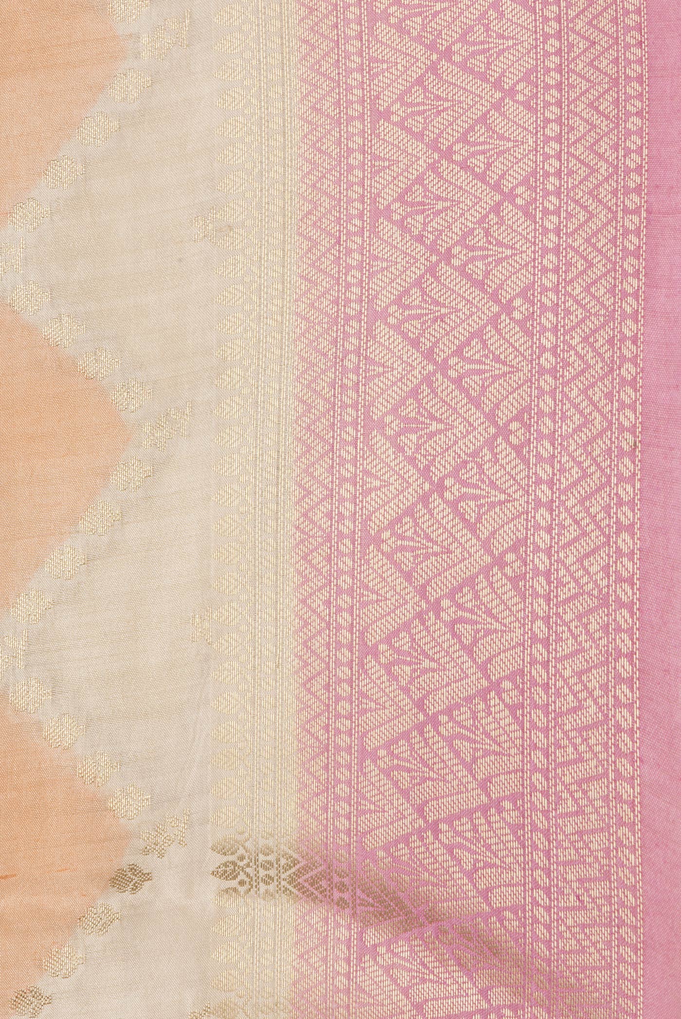 Close up of Pink, Orange and Sandal Color Tussar Silk Saree with Zig Zag design on the body and Zari Border.  displaying folds