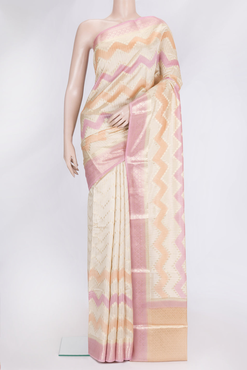 Pink, Orange and Sandal Color Tussar Silk Saree with Zig Zag design on the body and Zari Border.  displayed on a mannequin