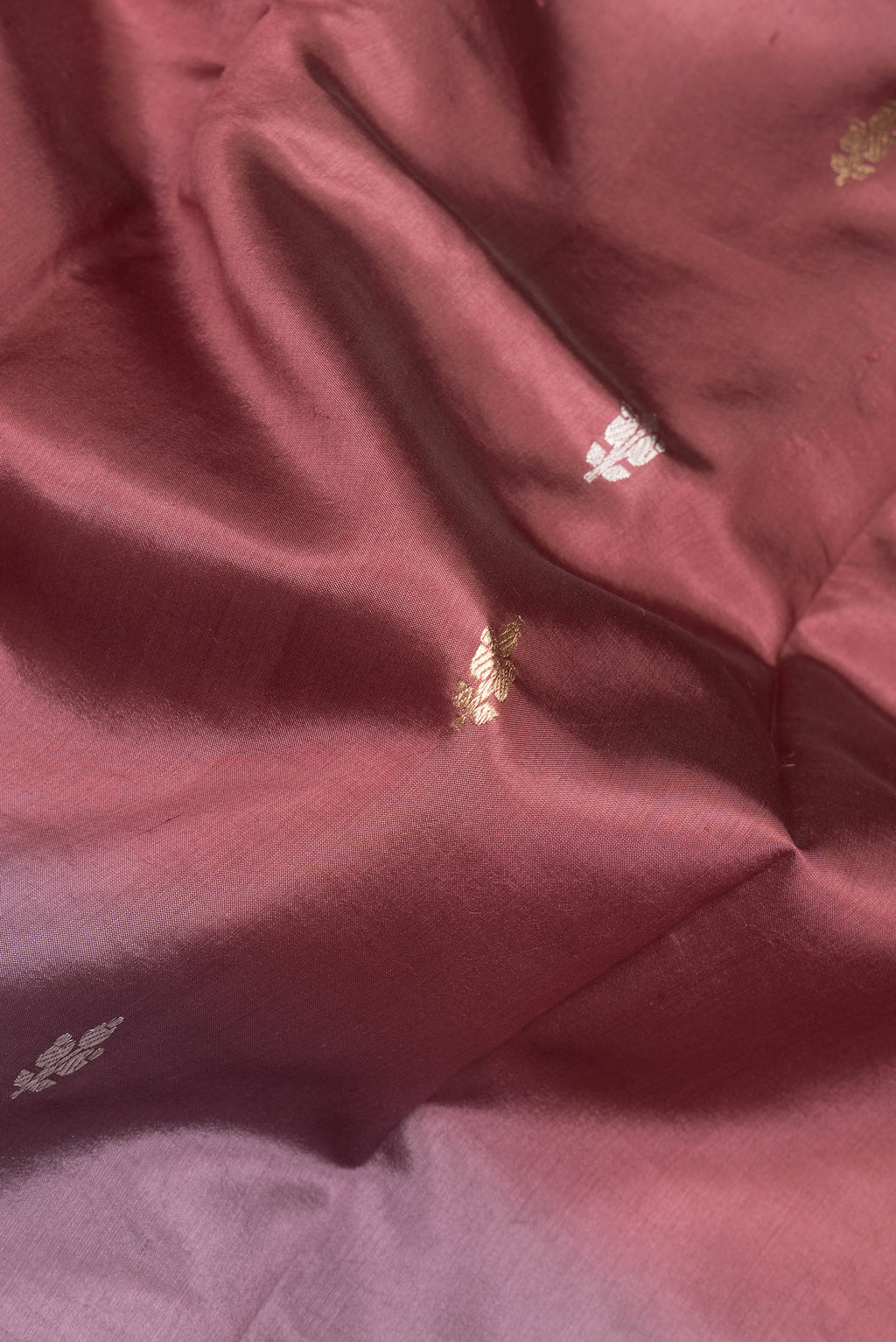 Close up of Multi Color Tussar Silk Saree with Zari Butta on the body and Plain Border.  displaying folds