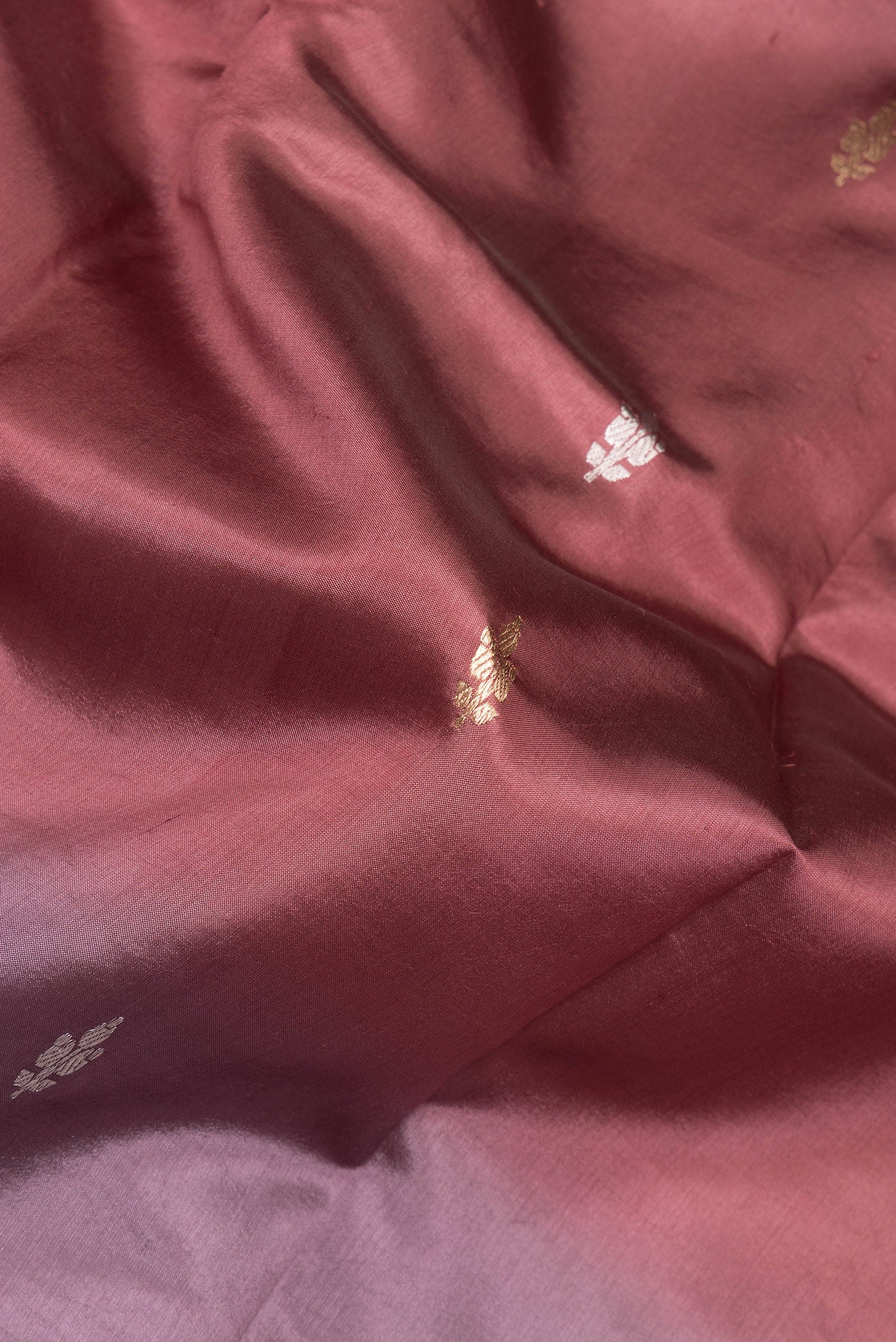 Close up of Multi Color Tussar Silk Saree with Zari Butta on the body and Plain Border.  displaying folds