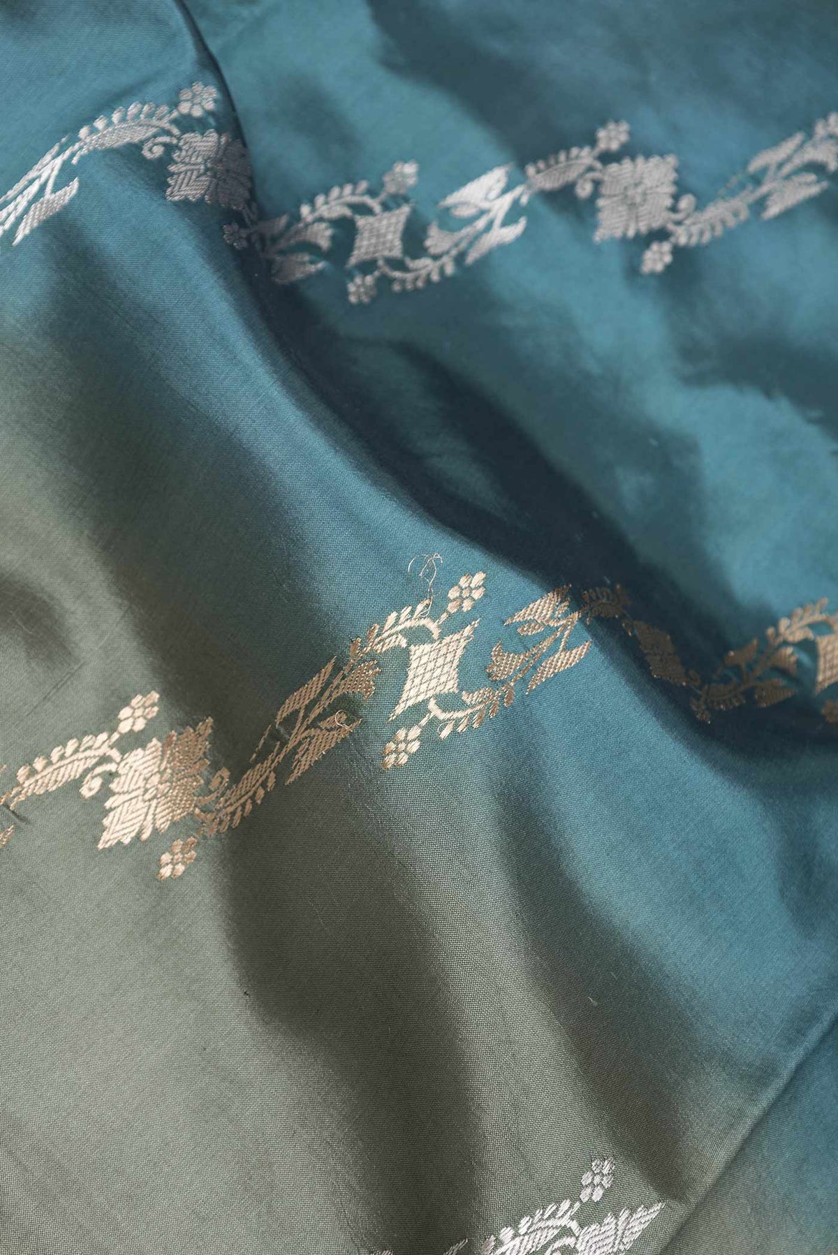 Close up of Blue Grey Dual Tone Tussar Silk Saree with Zari Brocade on the body and Without Border displaying folds