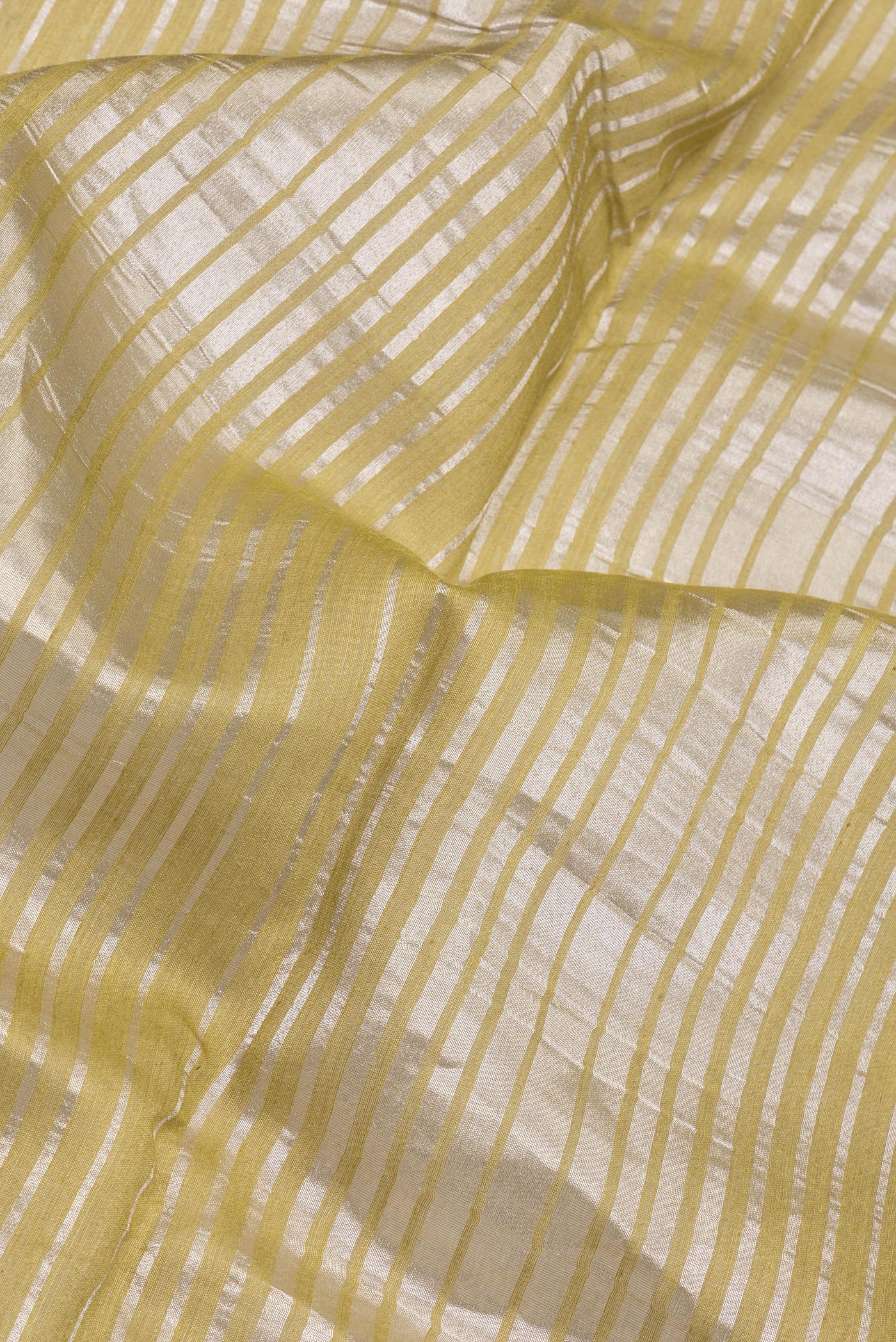 Close up of Multi Color Tussar Silk Saree with Stripes on the body and Zari Border.  displaying folds