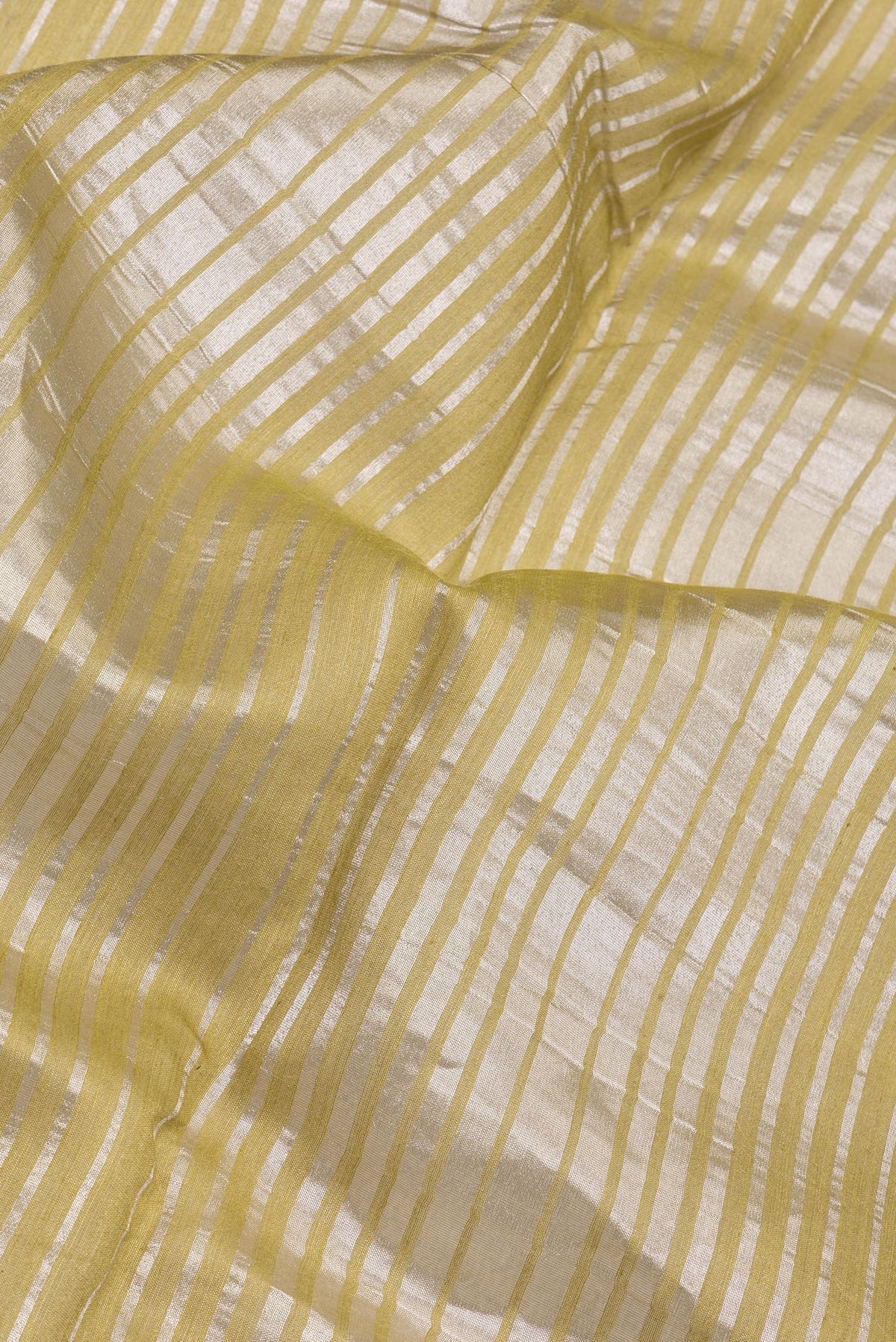 Close up of Multi Color Tussar Silk Saree with Stripes on the body and Zari Border.  displaying folds