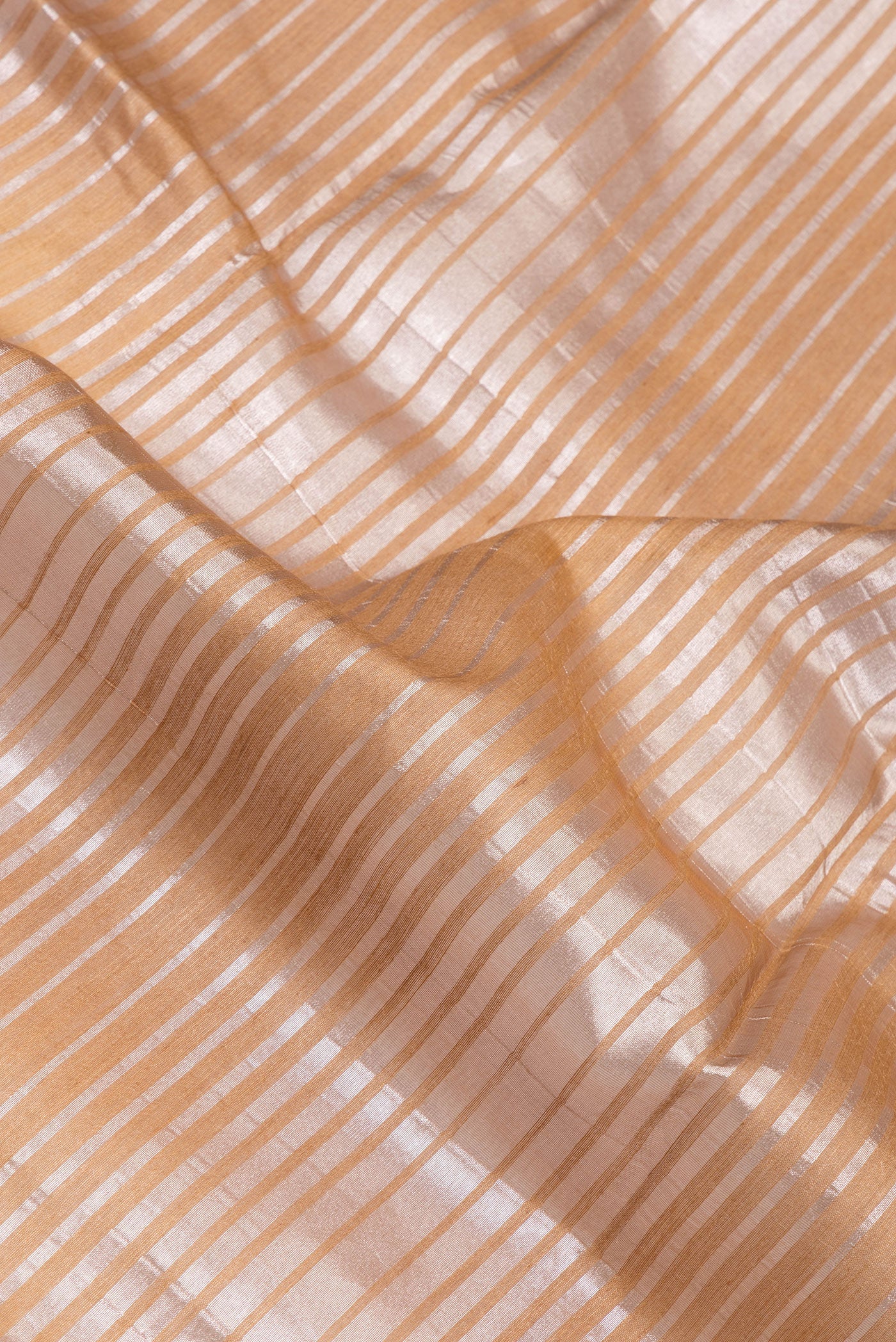 Close up of Multi Color Tussar Silk Saree with Stripes on the body and Zari Border.  displaying folds