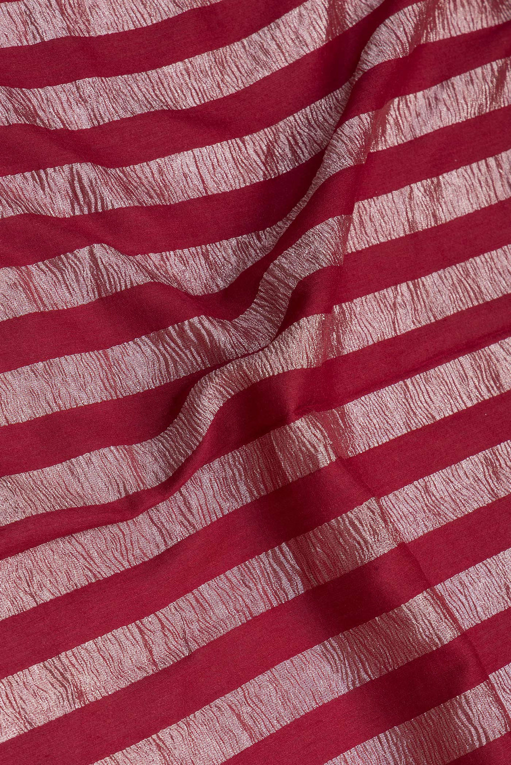 Close up of Maroon Tussar Silk Saree with Stripes on the body and Zari Border.  displaying folds