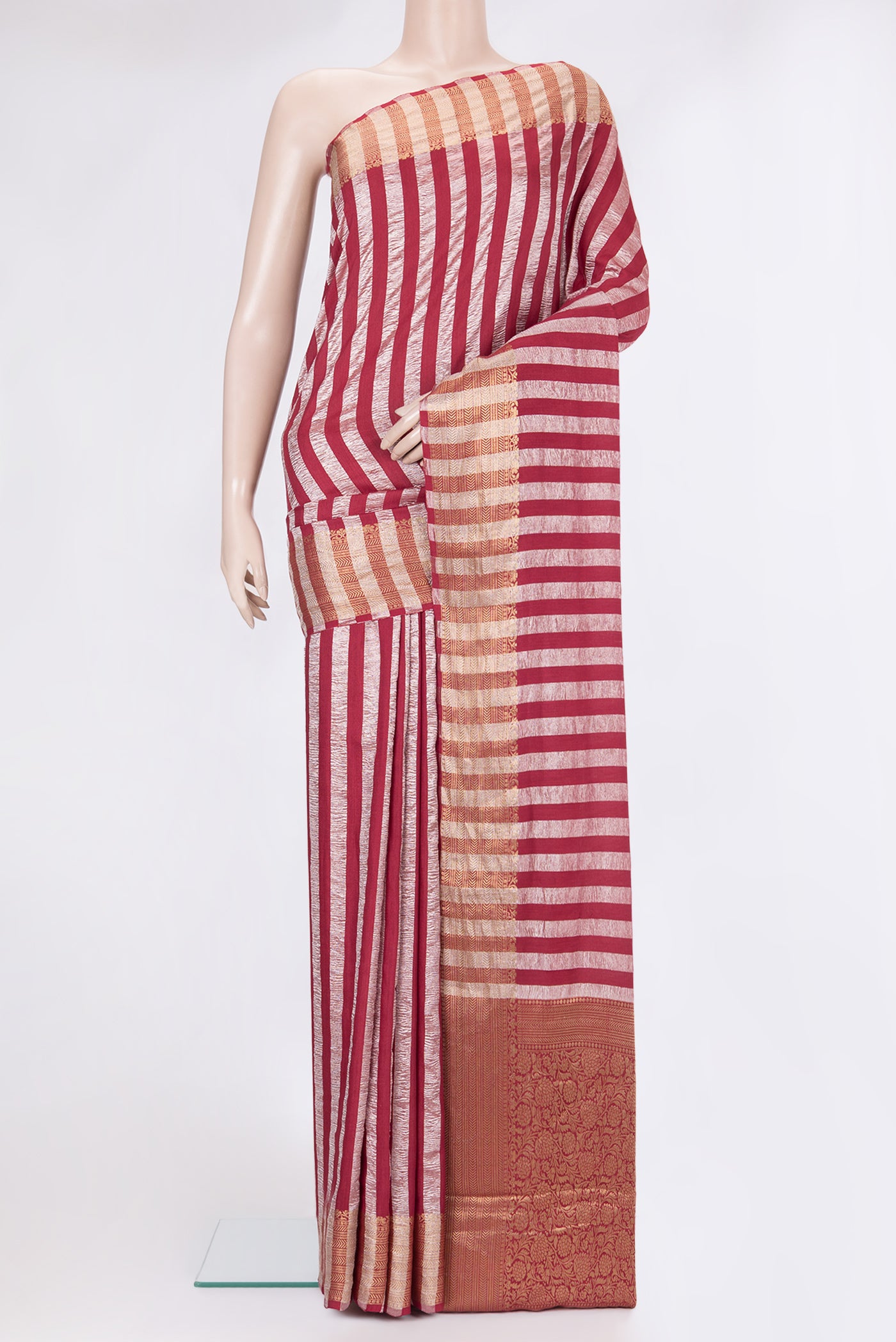 Maroon Tussar Silk Saree with Stripes on the body and Zari Border.  displayed on a mannequin