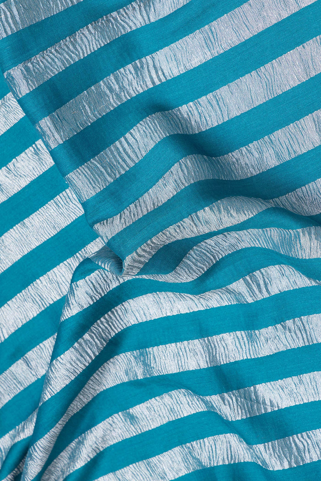 Close up of Sky Blue Dual Tone Tussar Silk Saree with Stripes on the body and Zari Border.  displaying folds