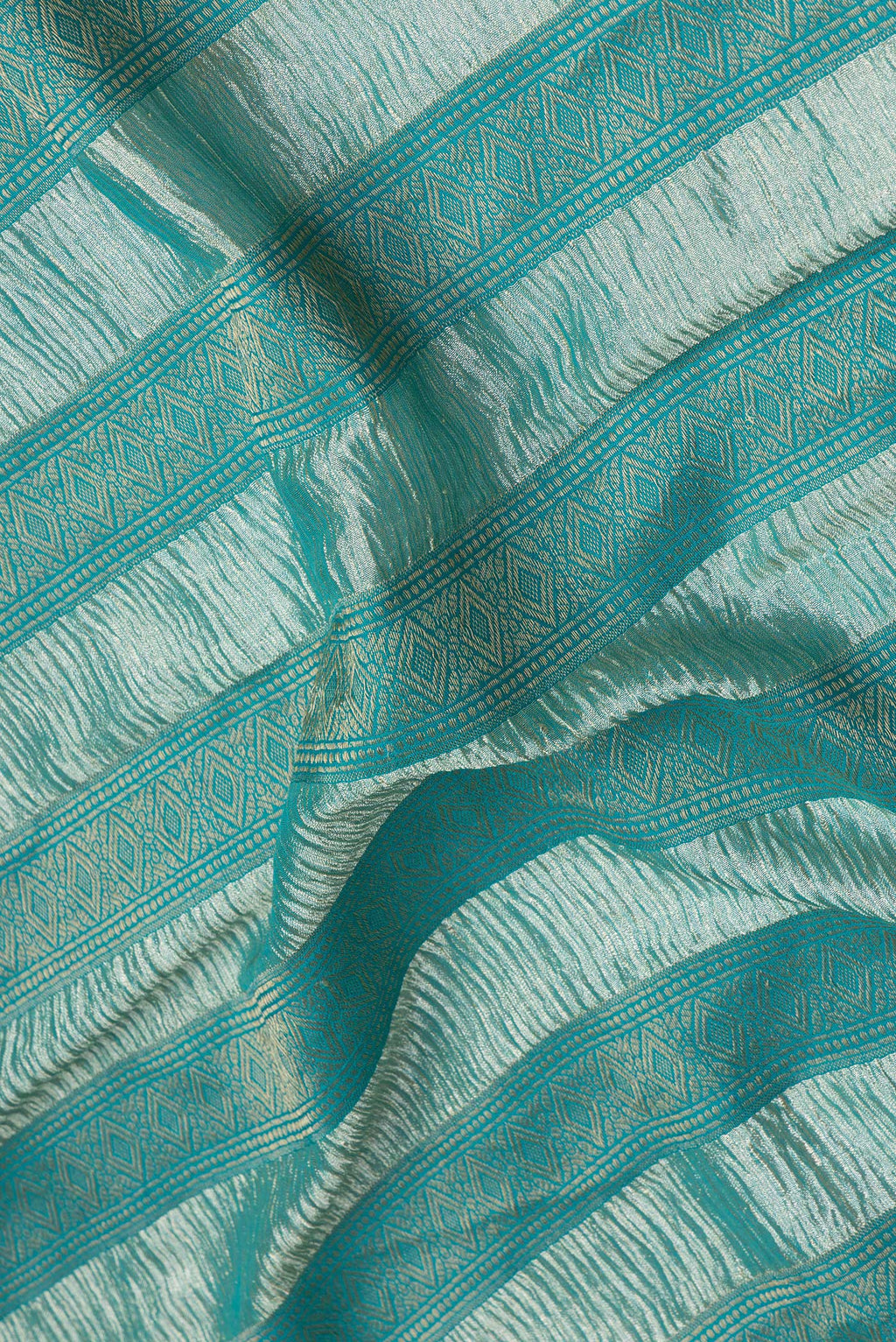 Close up of Sky Blue Dual Tone Tussar Silk Saree with Stripes on the body and Zari Border.  displaying folds