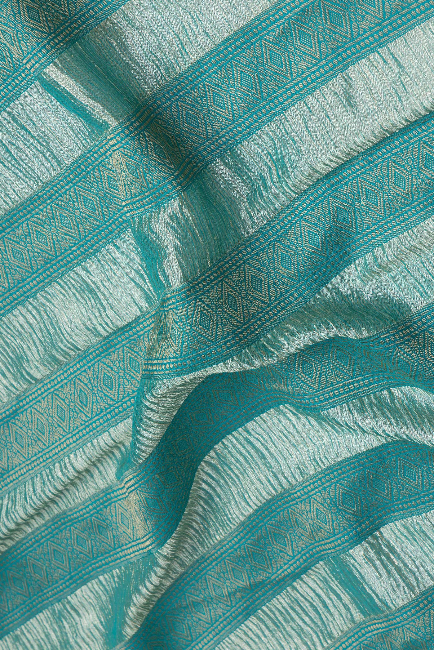 Close up of Sky Blue Dual Tone Tussar Silk Saree with Stripes on the body and Zari Border.  displaying folds