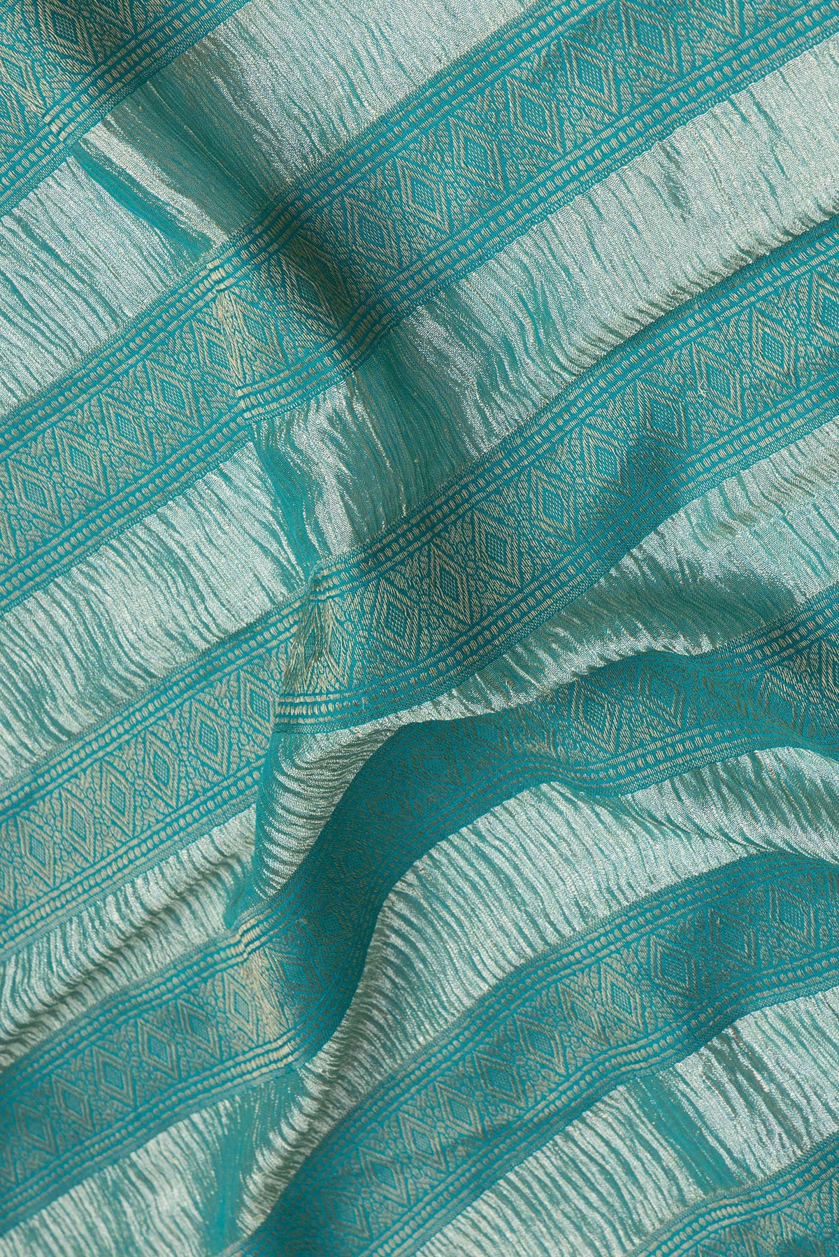 Close up of Sky Blue Dual Tone Tussar Silk Saree with Stripes on the body and Zari Border.  displaying folds