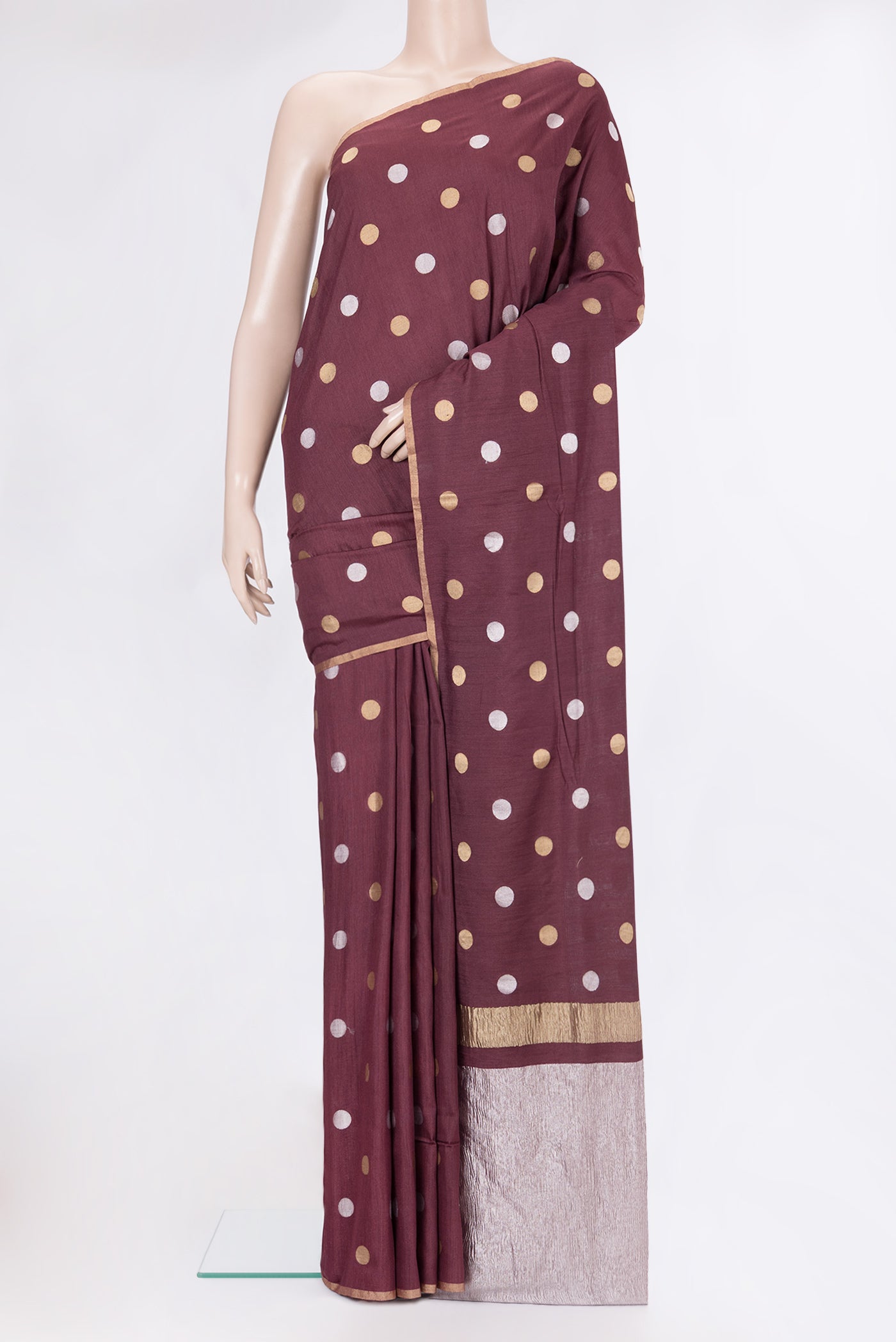 Burgundy Tussar Silk Saree with Polka Dots on the body and Zari Border.  displayed on a mannequin